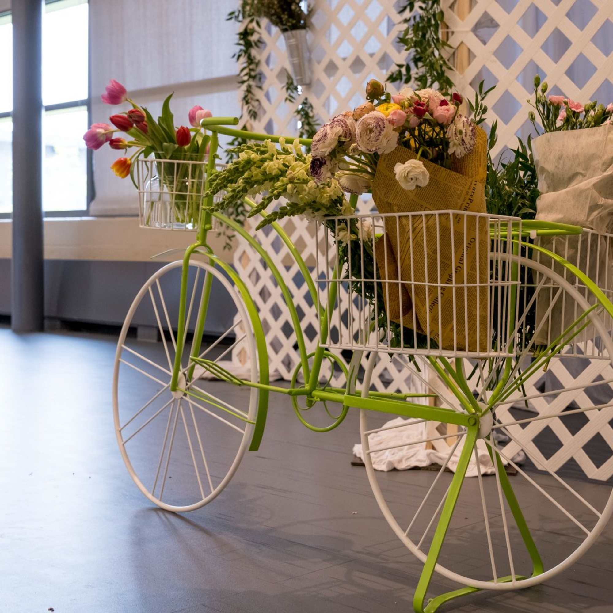 Flower-filled decorative tricycle with baskets of bouquets
