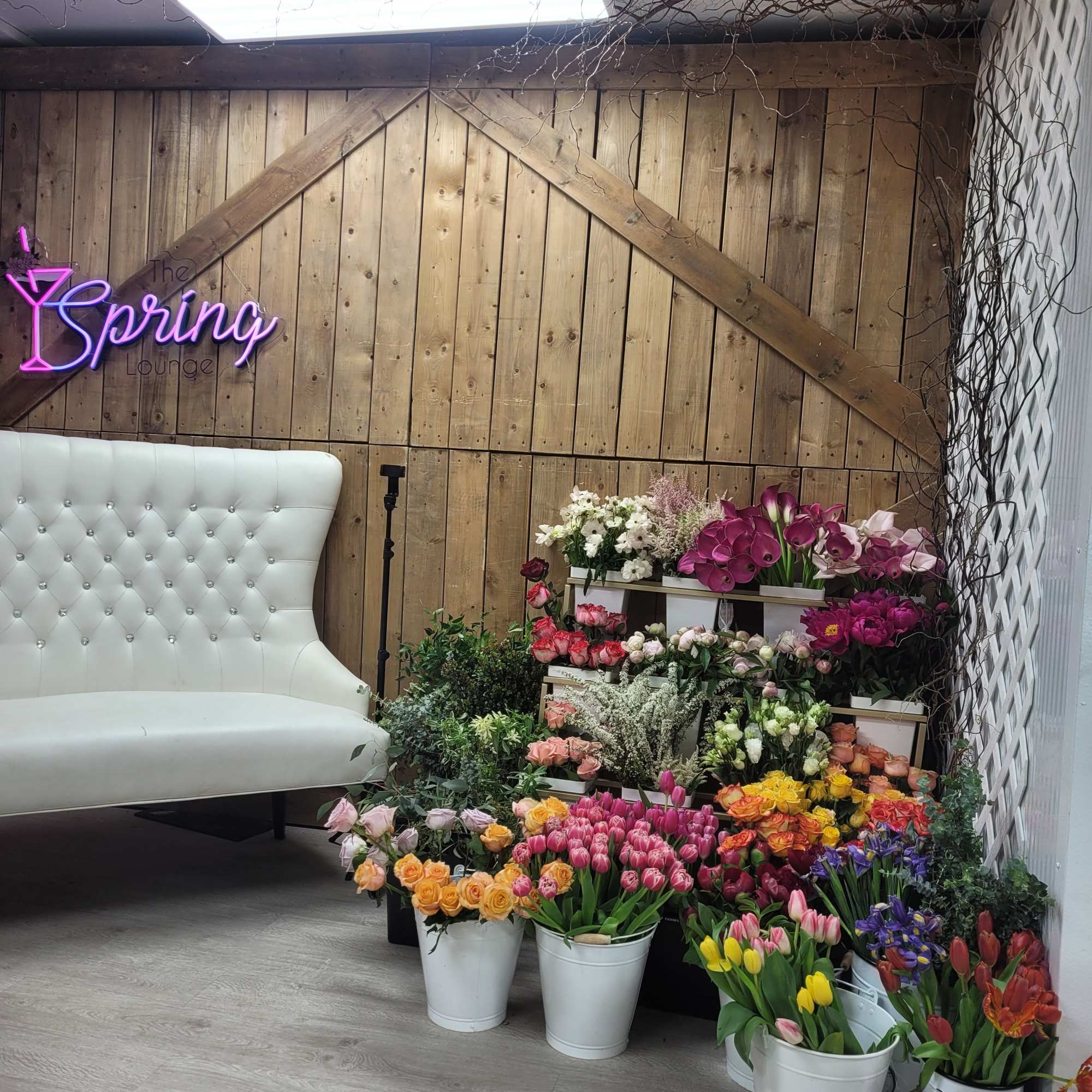 Assorted flower buckets with tulips, roses, calla lilies, and orchids