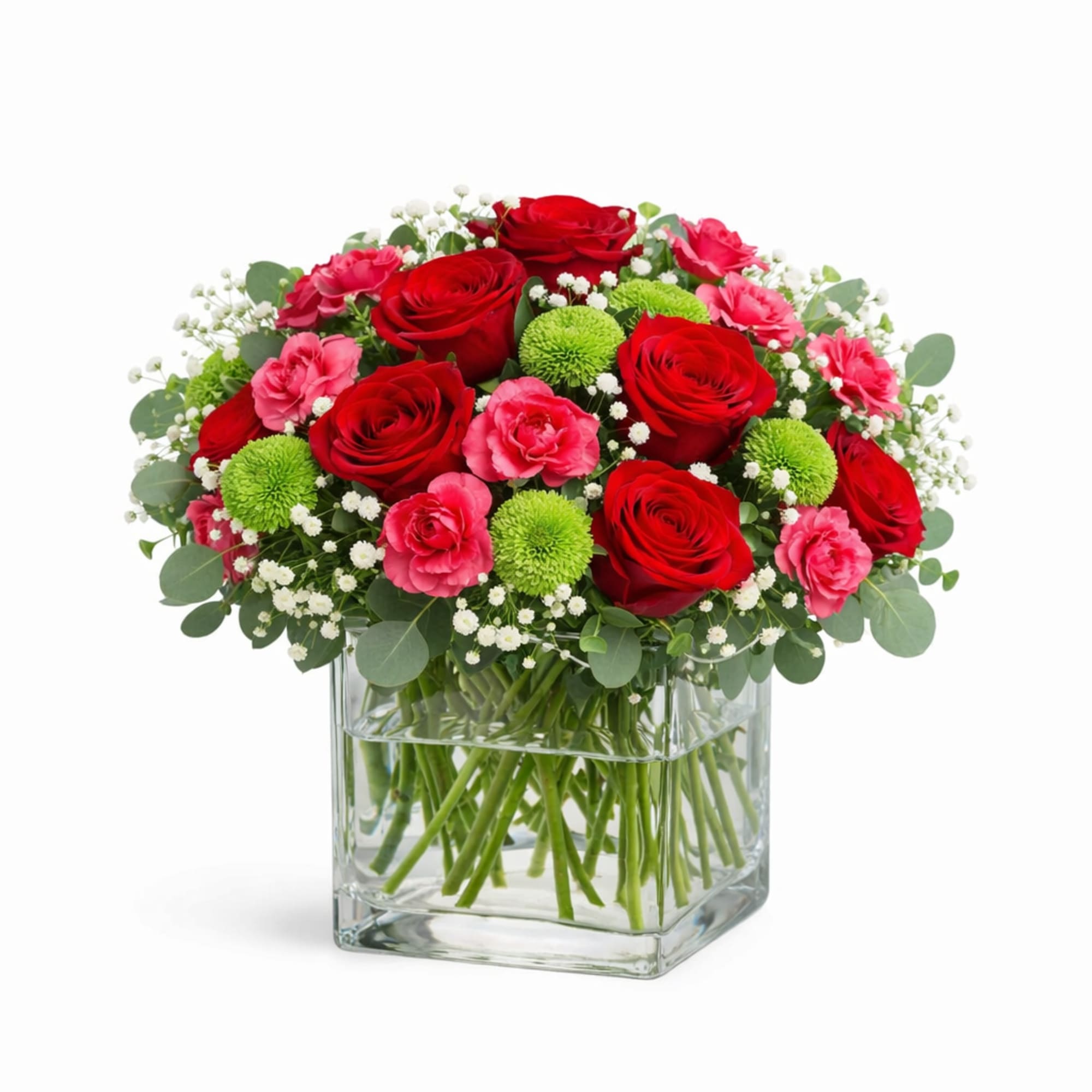 Red and pink roses arranged in a clear square vase