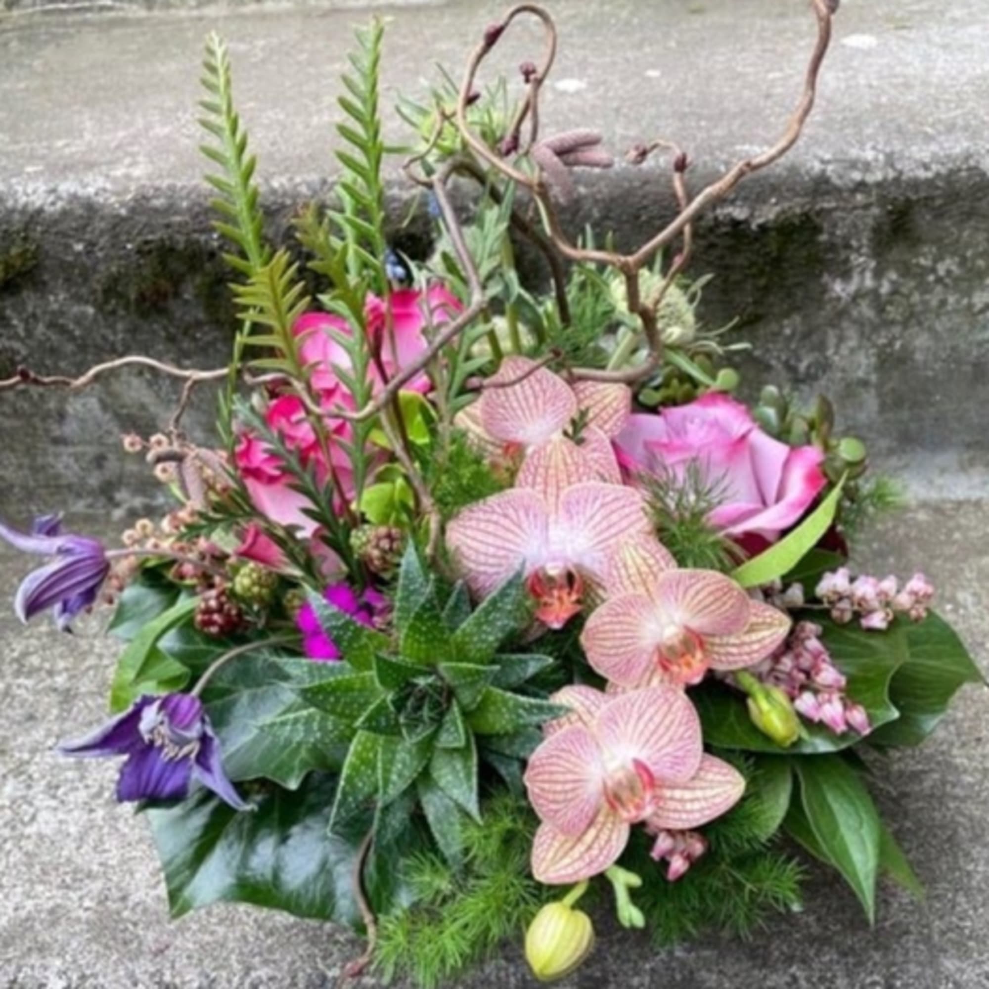 Mixed bouquet with pink orchids and purple flowers