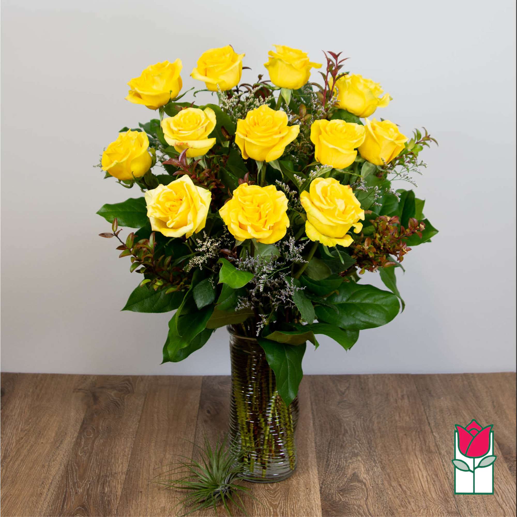Yellow roses arranged in a clear glass vase