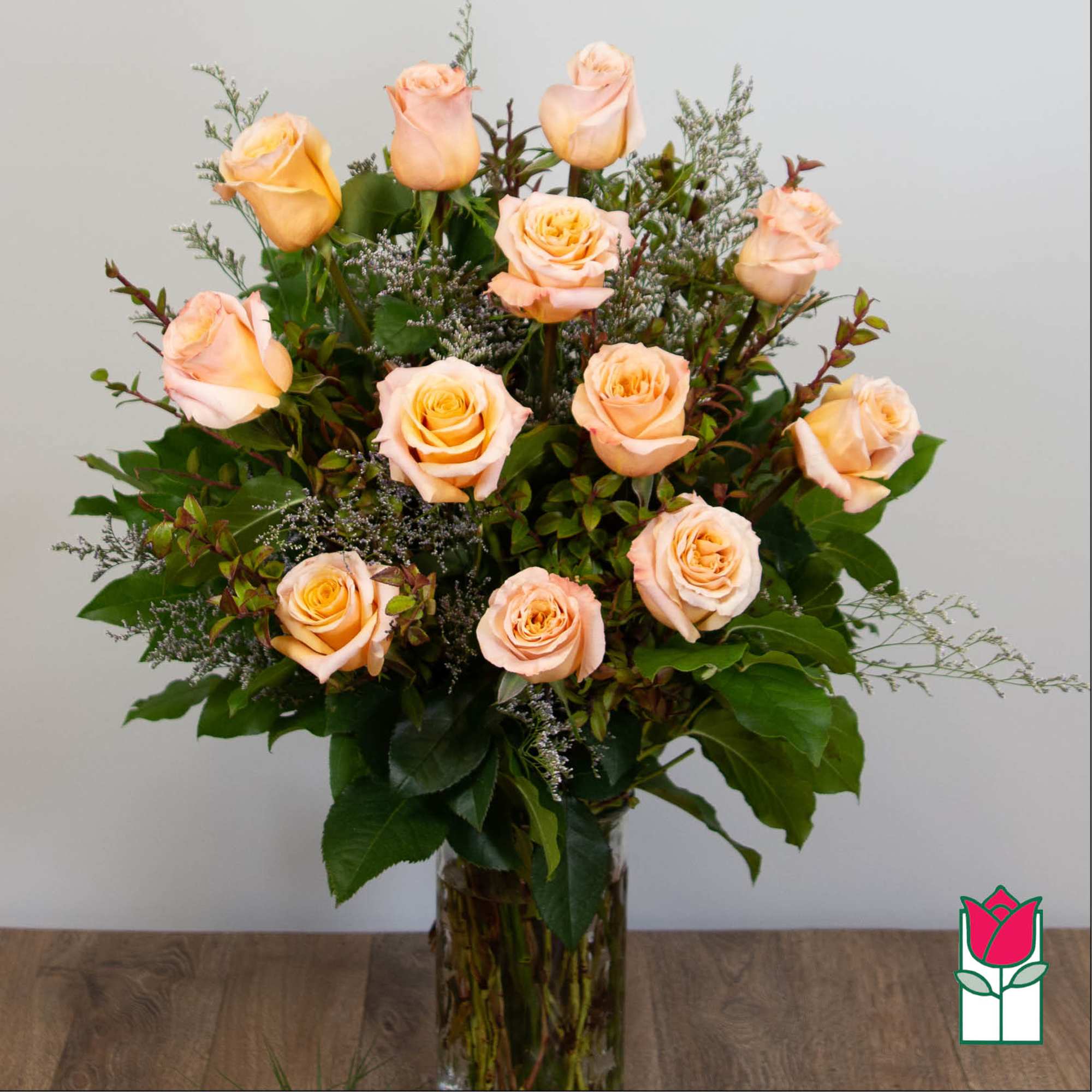 Peach roses arranged in a clear glass vase