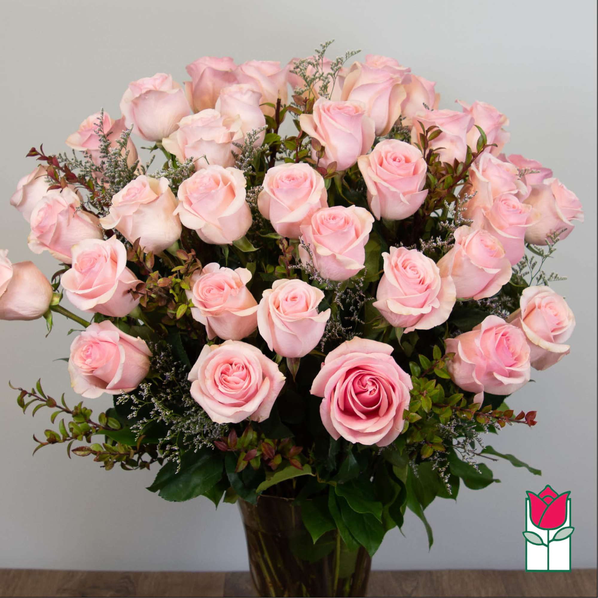 Bouquet of pale pink roses in a glass vase