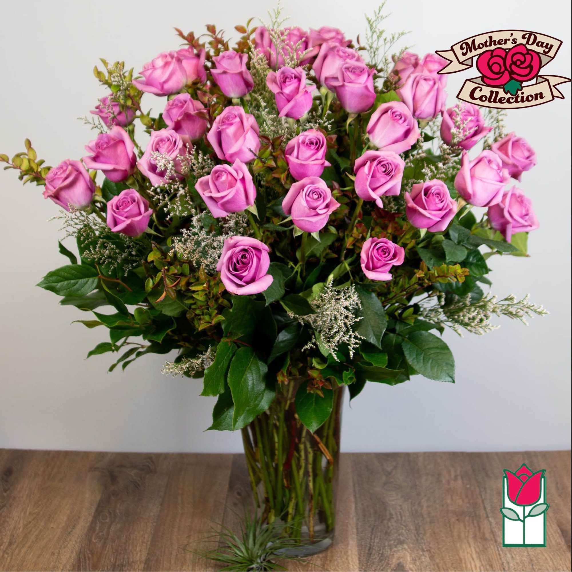 Tall bouquet of pink roses in a clear glass vase