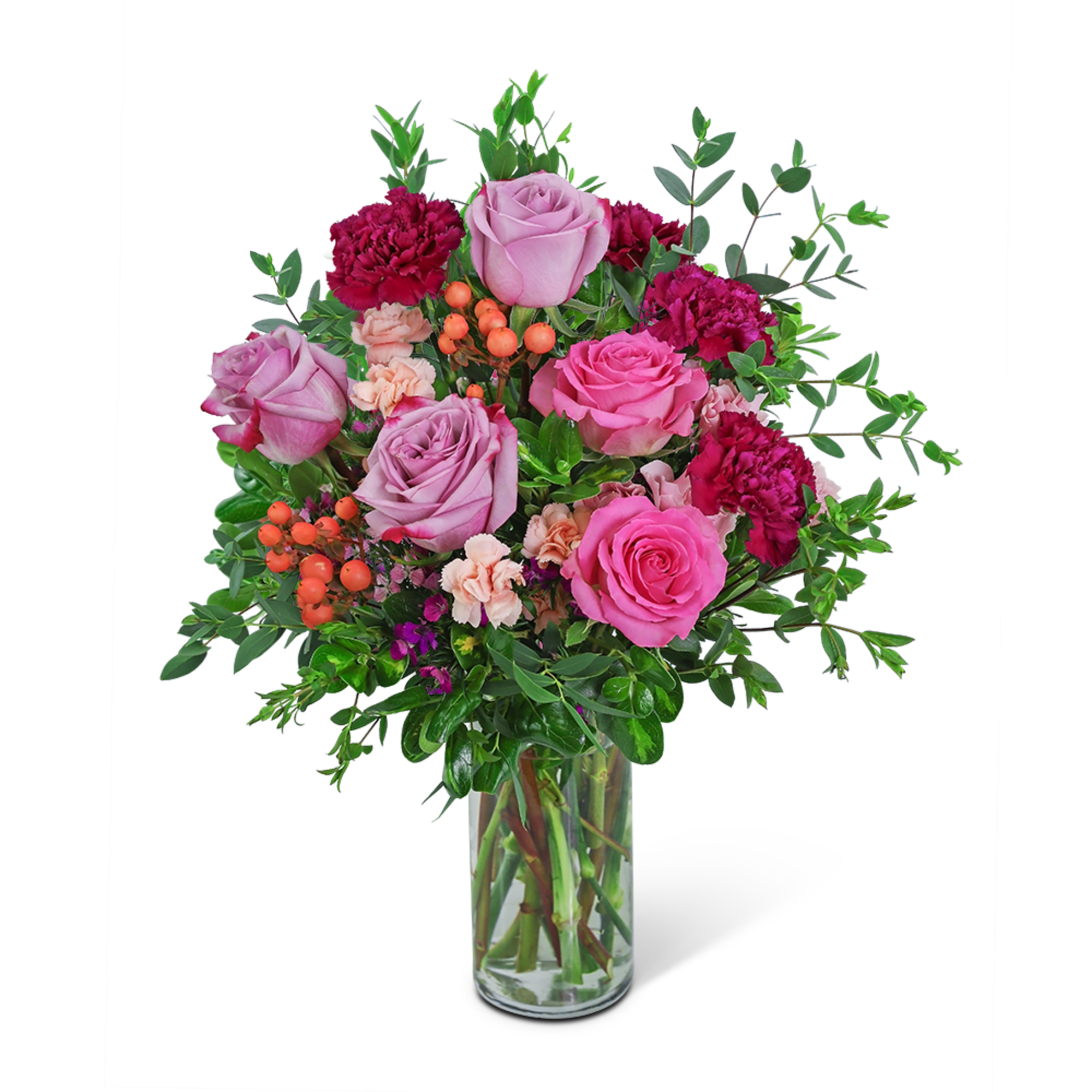 Pink roses and carnations in a clear glass vase