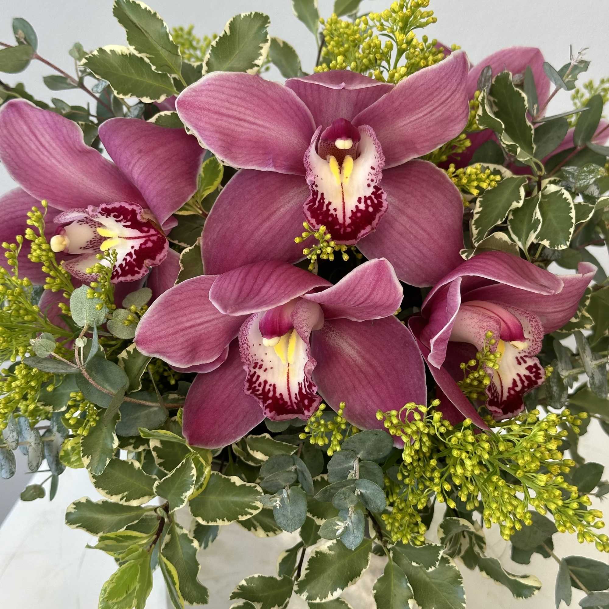 An elegant arrangement of pink cymbidium orchids. 