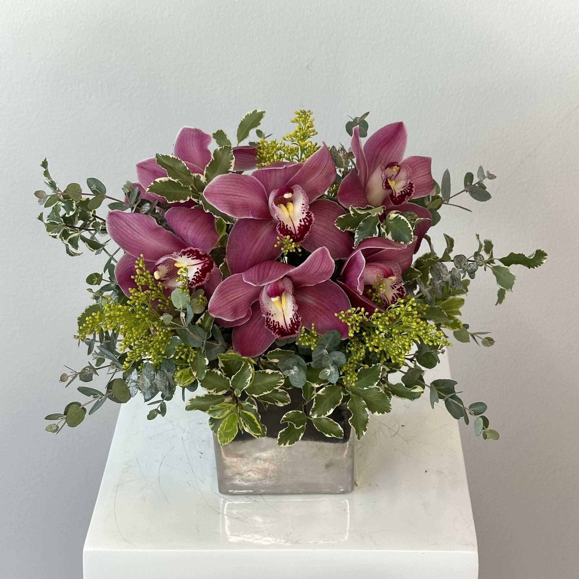 An elegant arrangement of pink cymbidium orchids. 