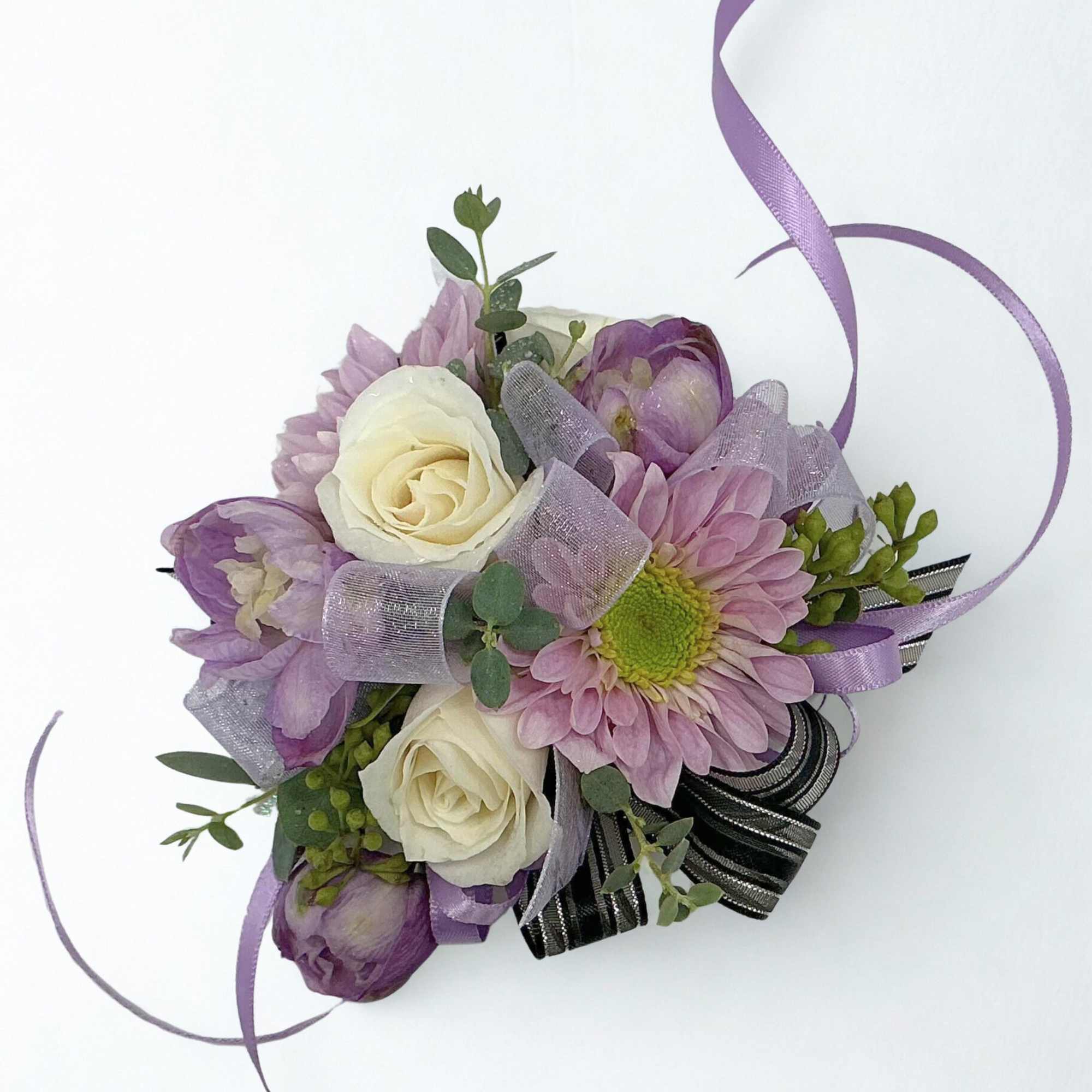 Small purple and white floral corsage with ribbon loops