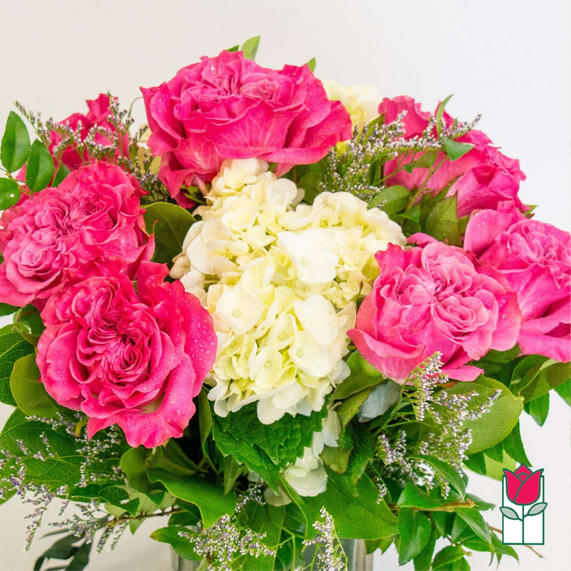 Bouquet of pink roses and white hydrangea with greenery