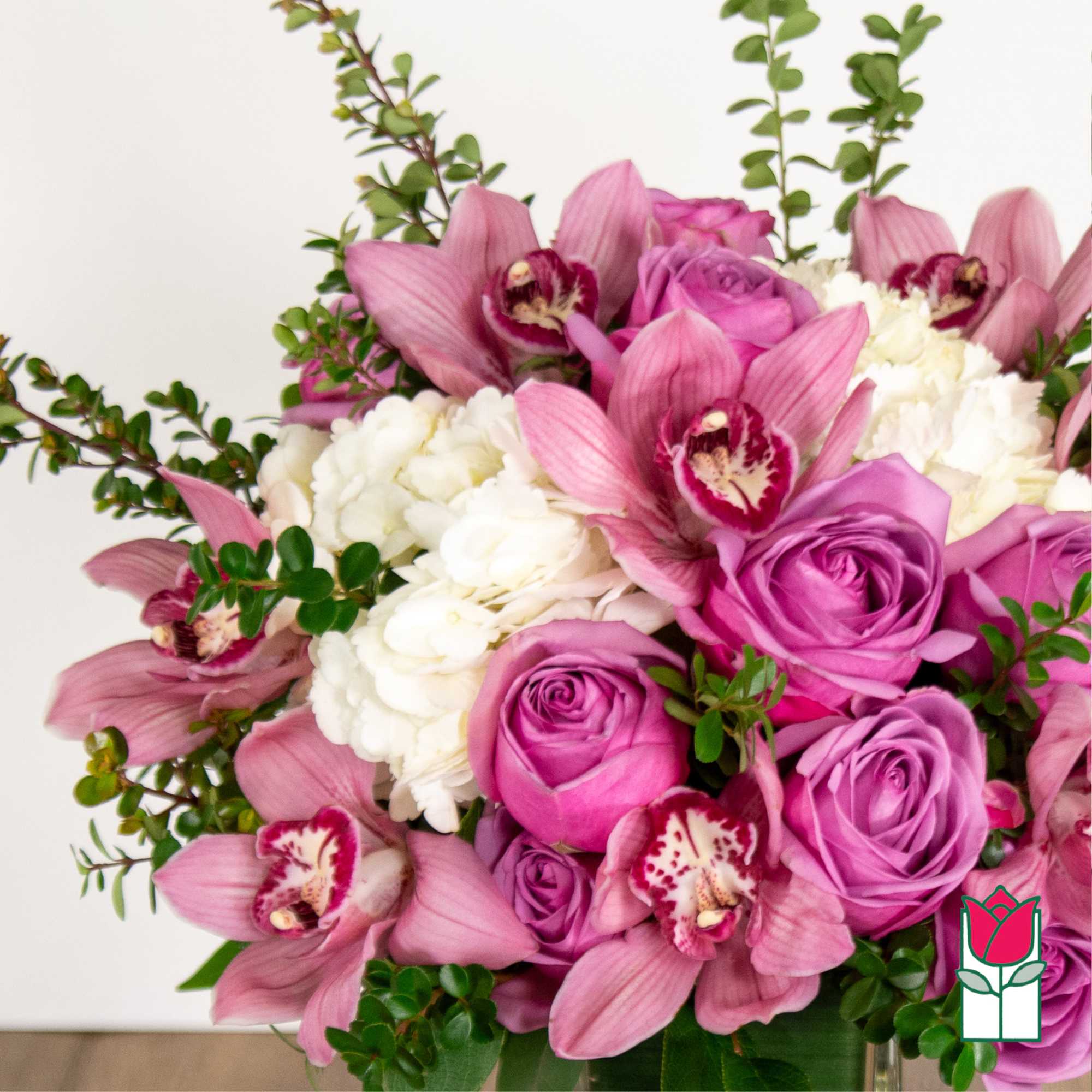 Pink roses and orchids with white hydrangeas in a bouquet