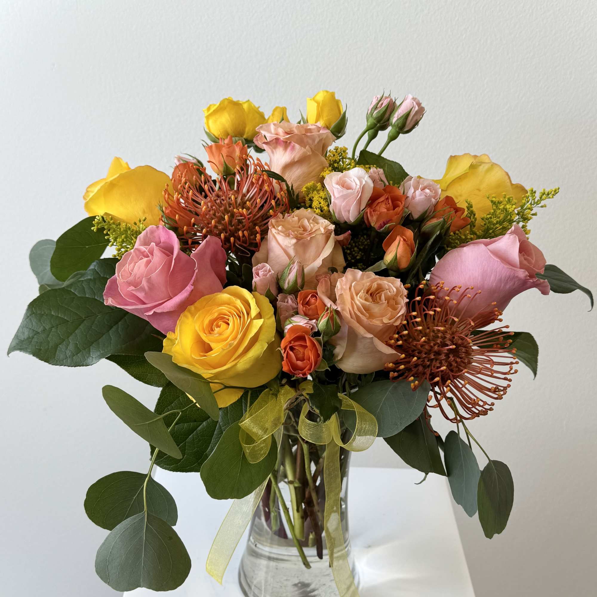 Sunburst Flower Arrangement &ndash; Vibrant Pincushion &amp; Multicolor Rose Bouquet with Solidago
Ignite