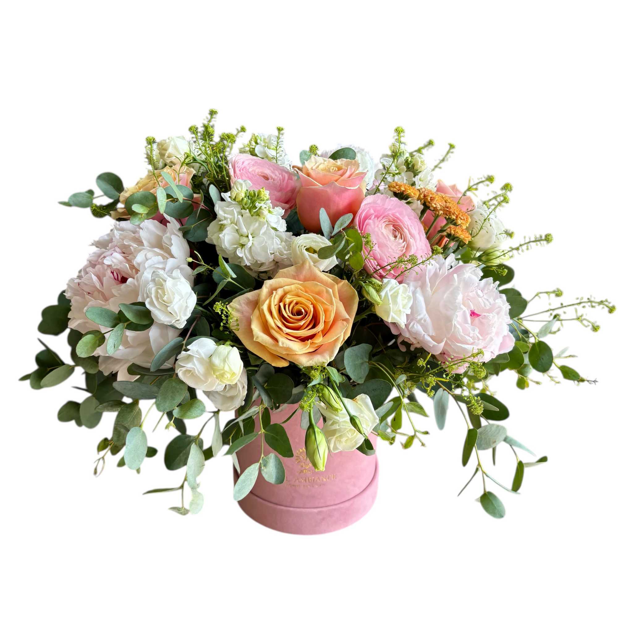 Pastel bouquet of roses, ranunculus, and peonies in a pink hatbox-style container