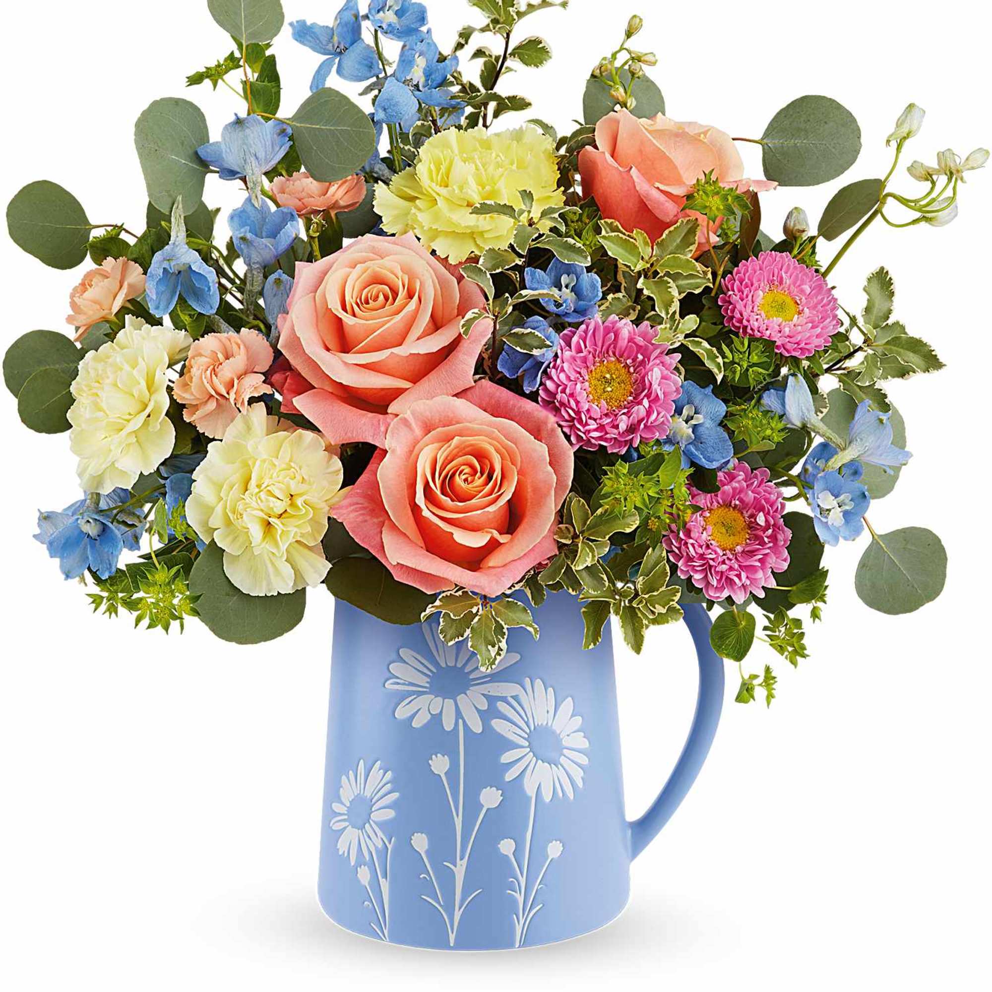 Mixed bouquet of peach roses, yellow carnations and blue and pink blooms in a blue daisy-print pitcher