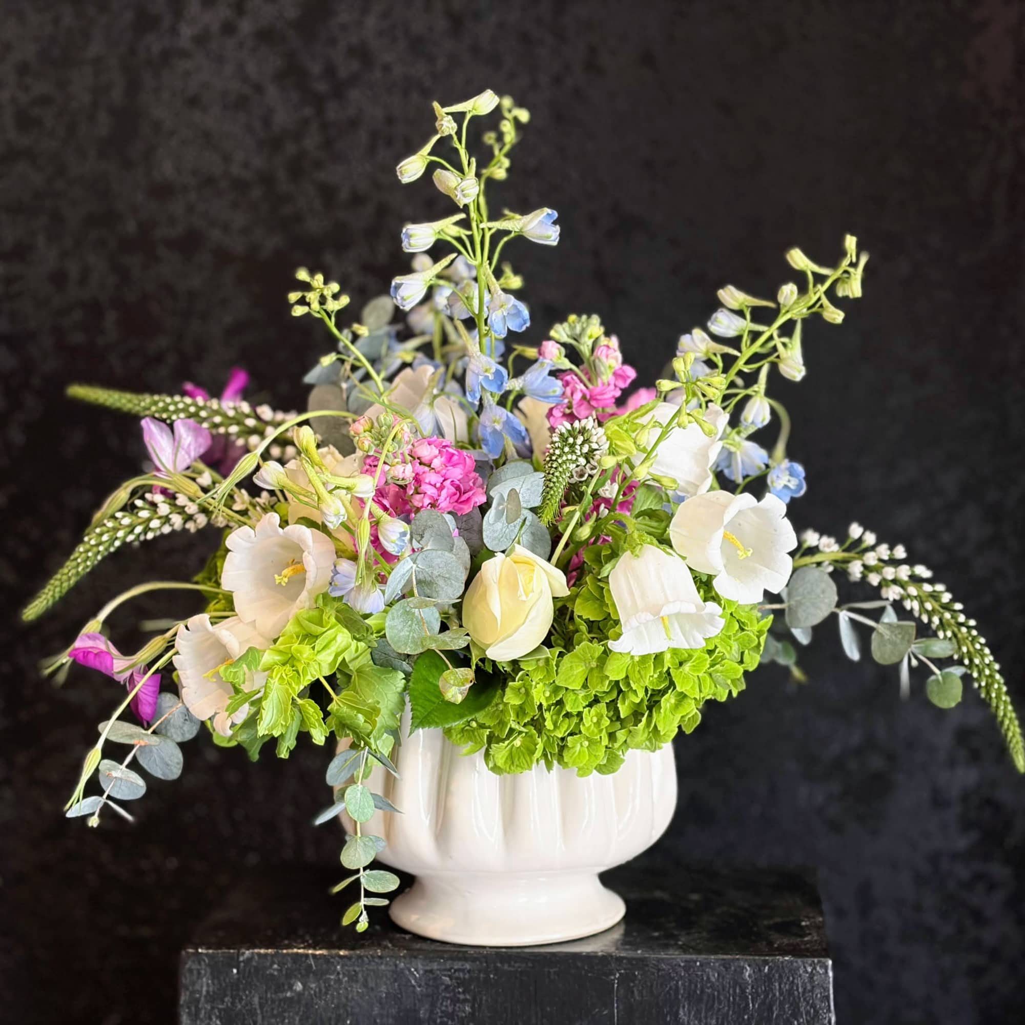 Soft Spring pastels and airy, garden-style movement make this floral arrangement the