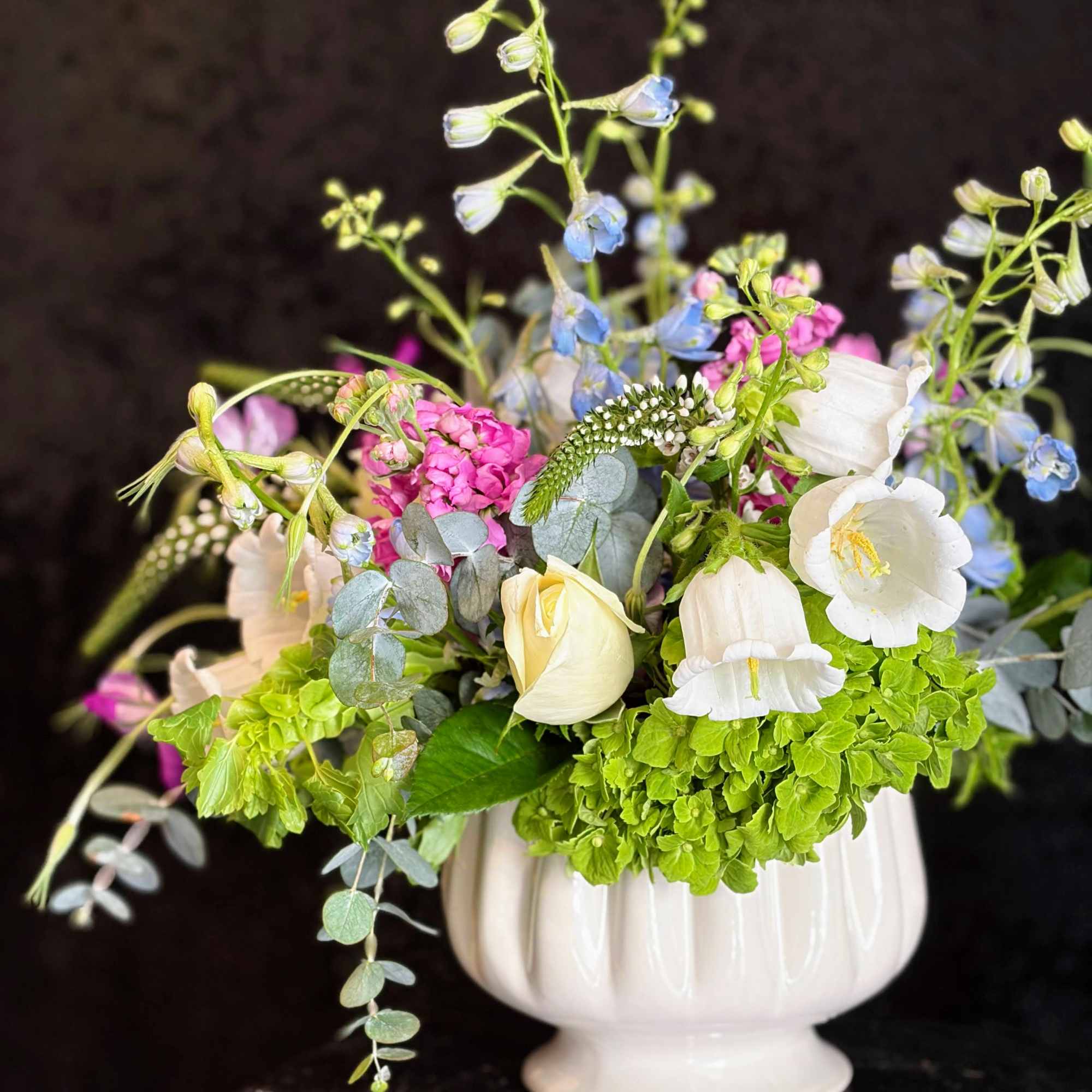 Soft Spring pastels and airy, garden-style movement make this floral arrangement the
