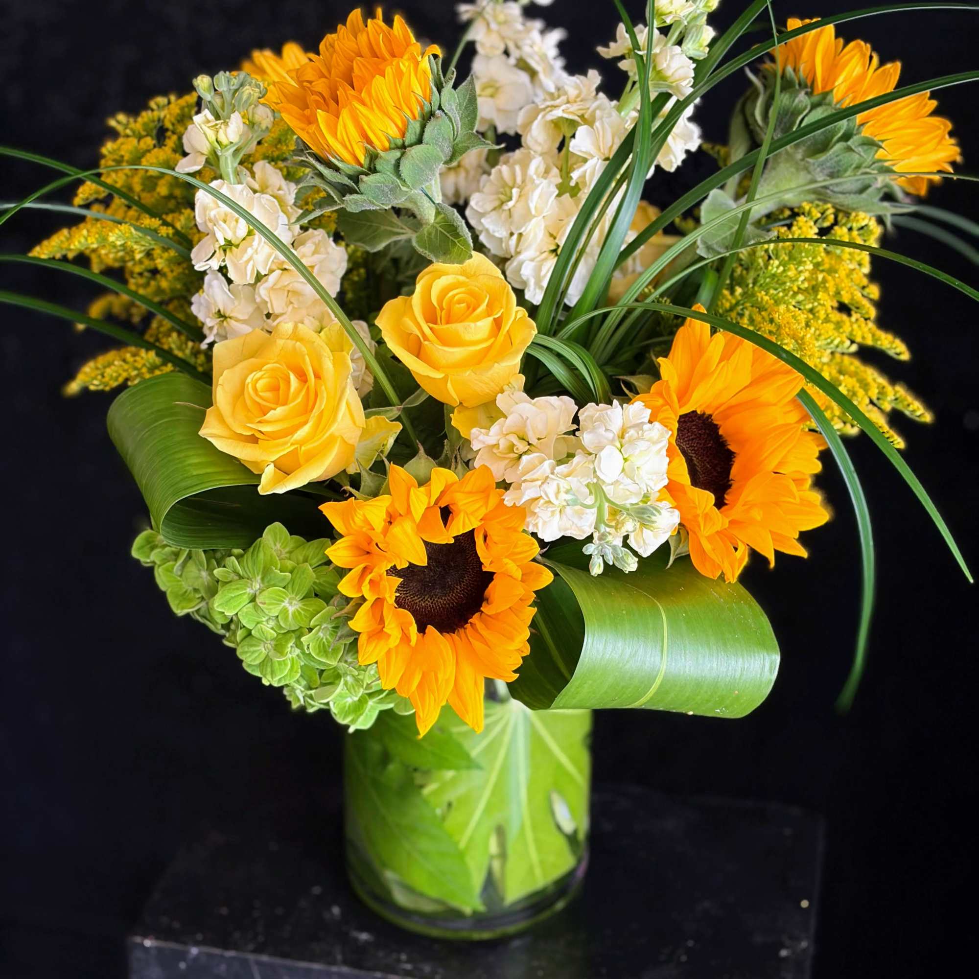 Sun-soaked and cheerful, this more traditional-style arrangement will brighten the home or