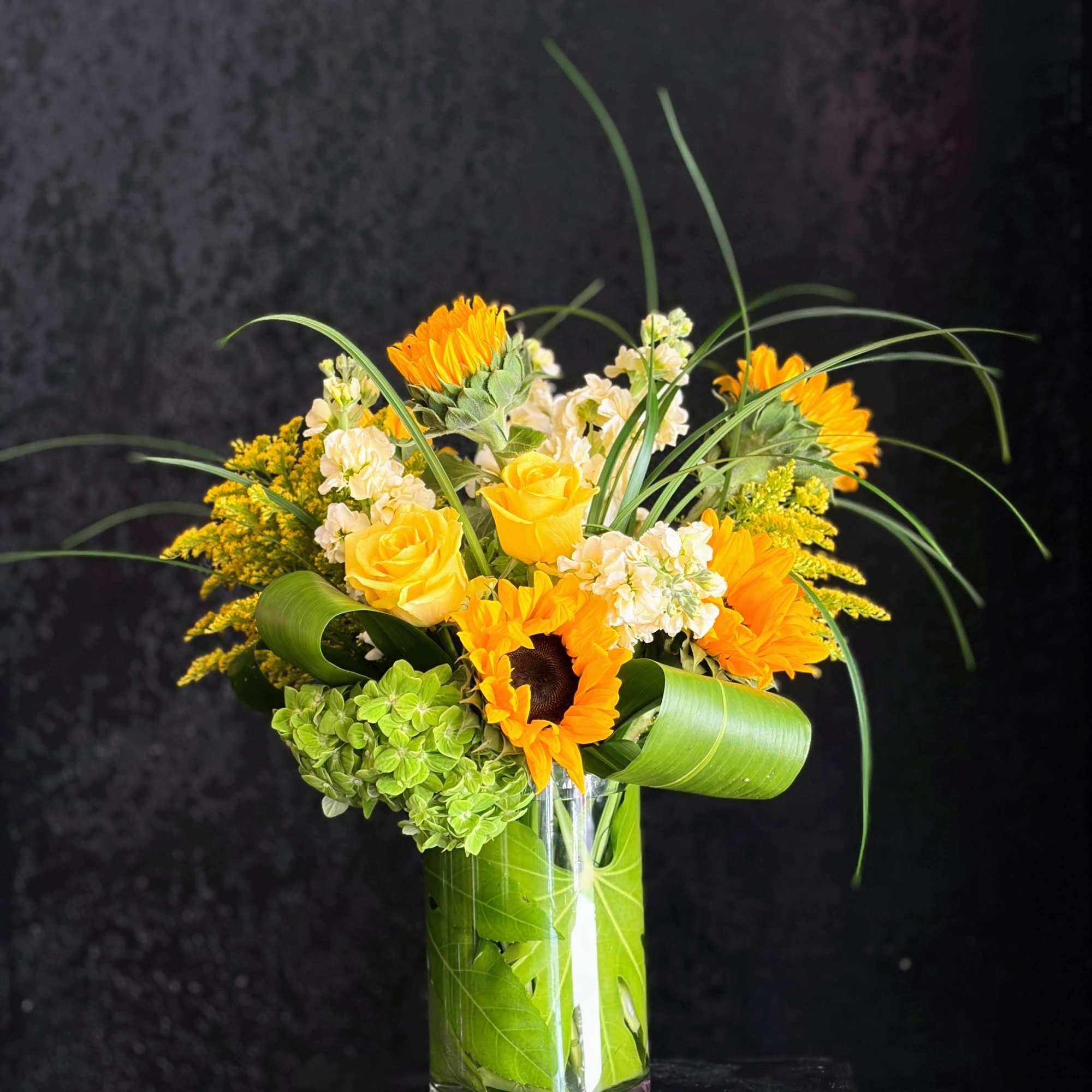 Sun-soaked and cheerful, this more traditional-style arrangement will brighten the home or