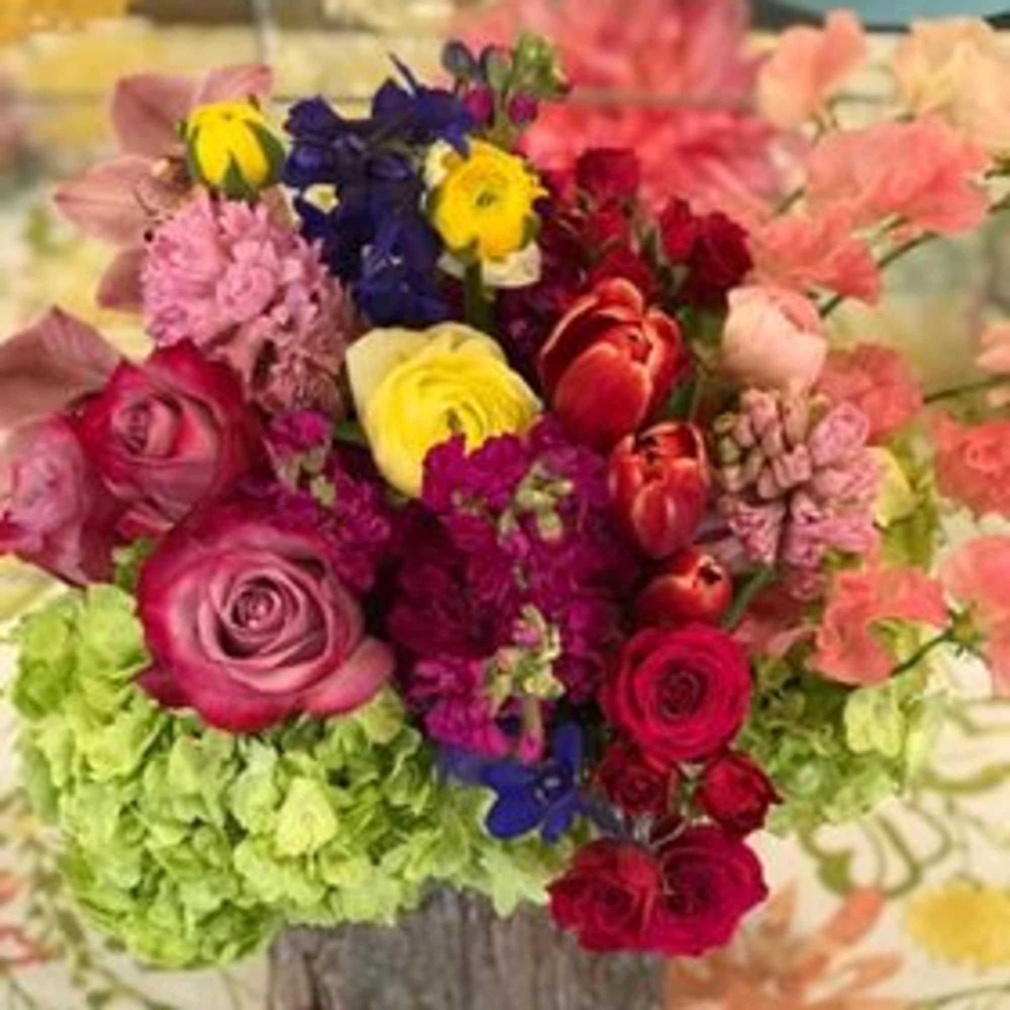 Colorful mixed bouquet in a rustic container