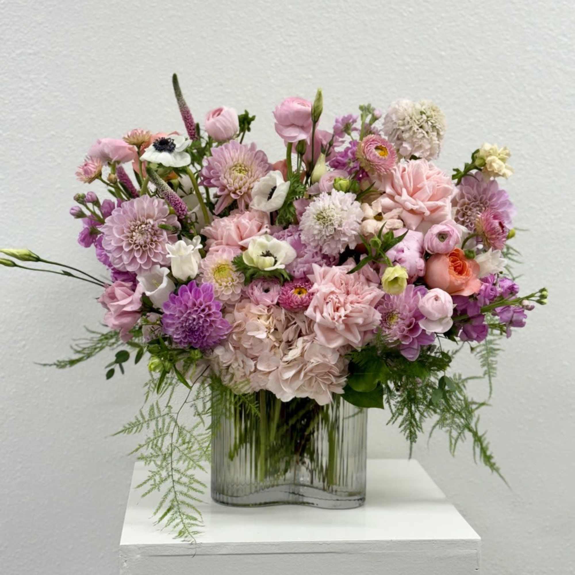 Pink and lavender mixed bouquet in a clear glass vase
