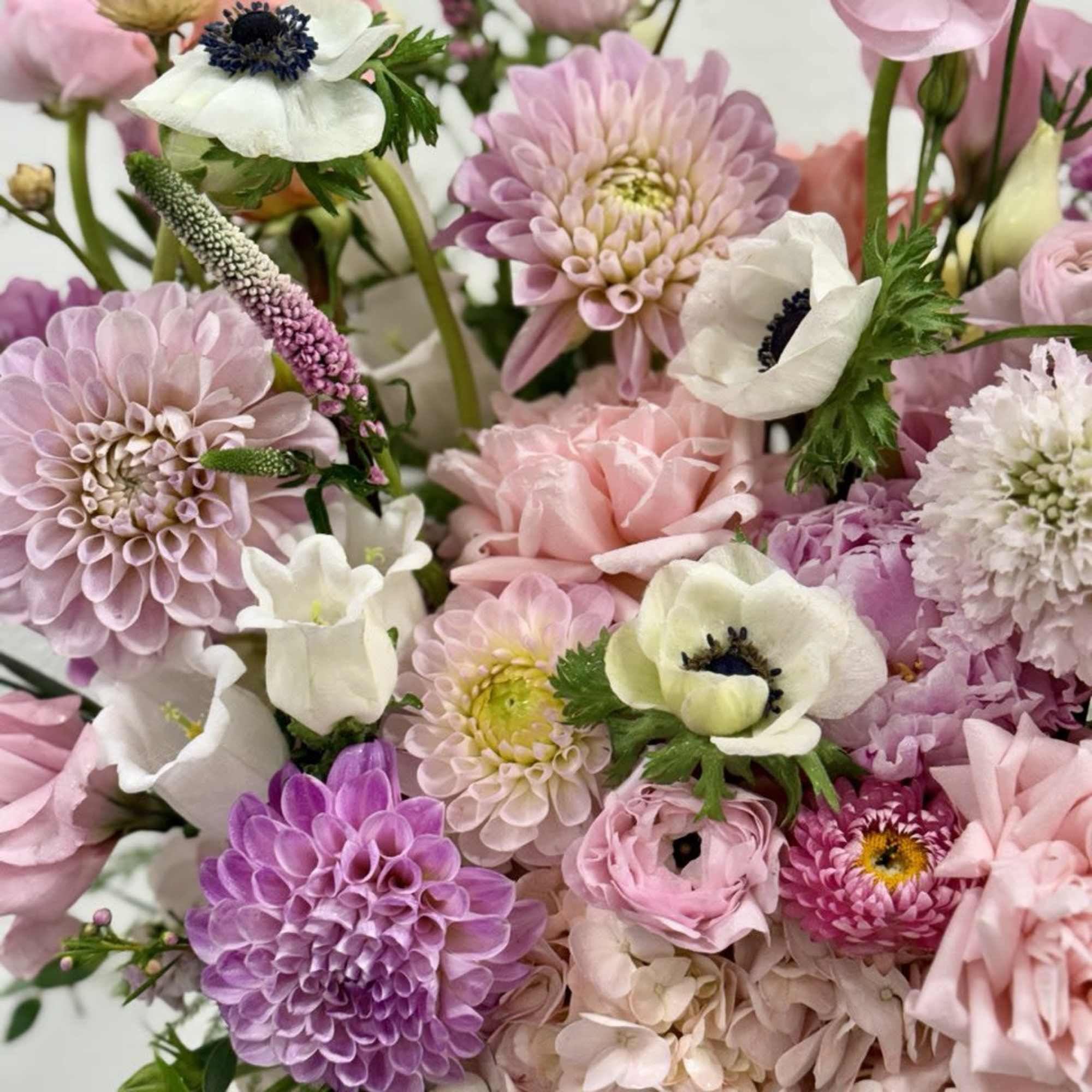 Pink and white mixed bouquet with dahlias, anemones, and hydrangeas