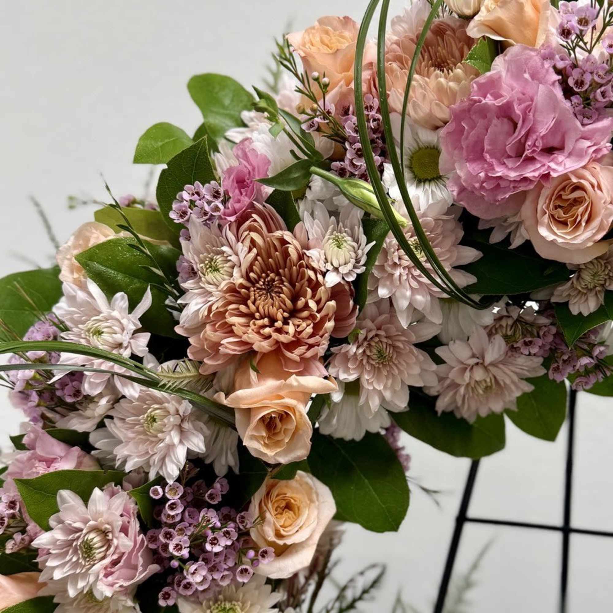 A beautiful white and green tribute wreath that calms, this easel arrangement