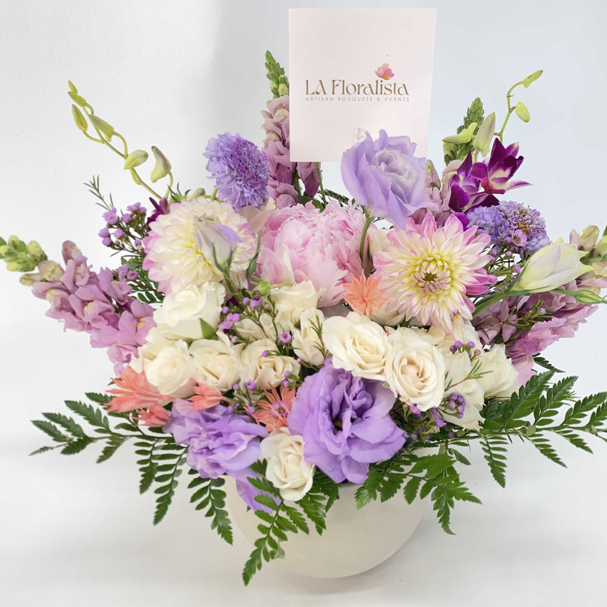 Peonies, Dahlias, butterfly ranunculus, Hydrangeas and fillers. All in soft pastels colors.