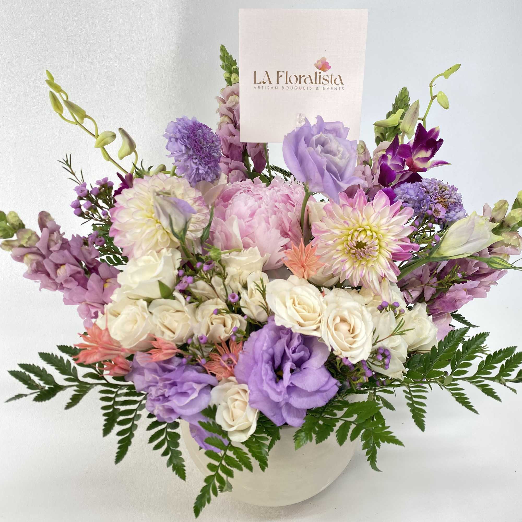 Peonies, Dahlias, butterfly ranunculus, Hydrangeas and fillers. All in soft pastels colors.