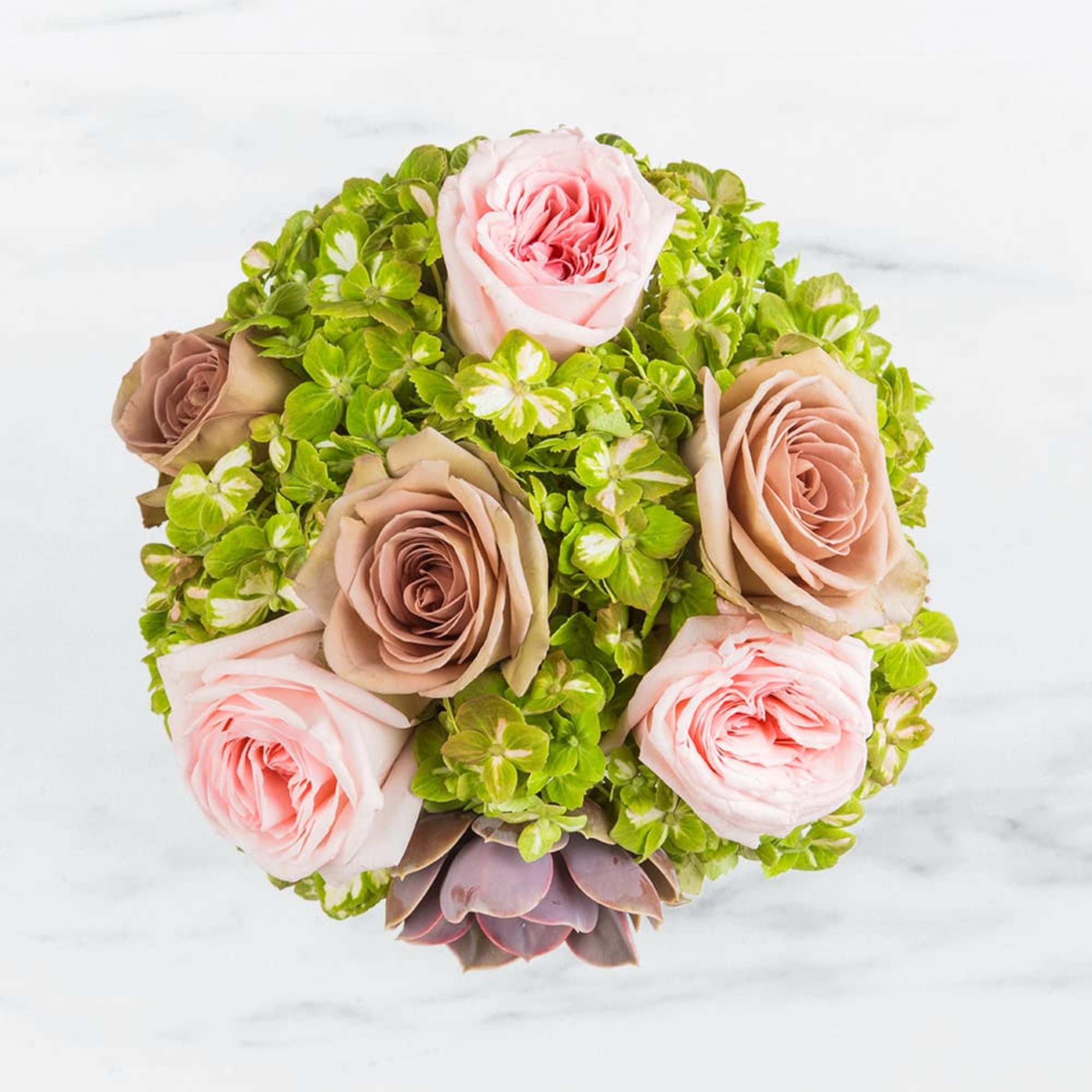 Round bouquet of pink and taupe roses with bright green hydrangea