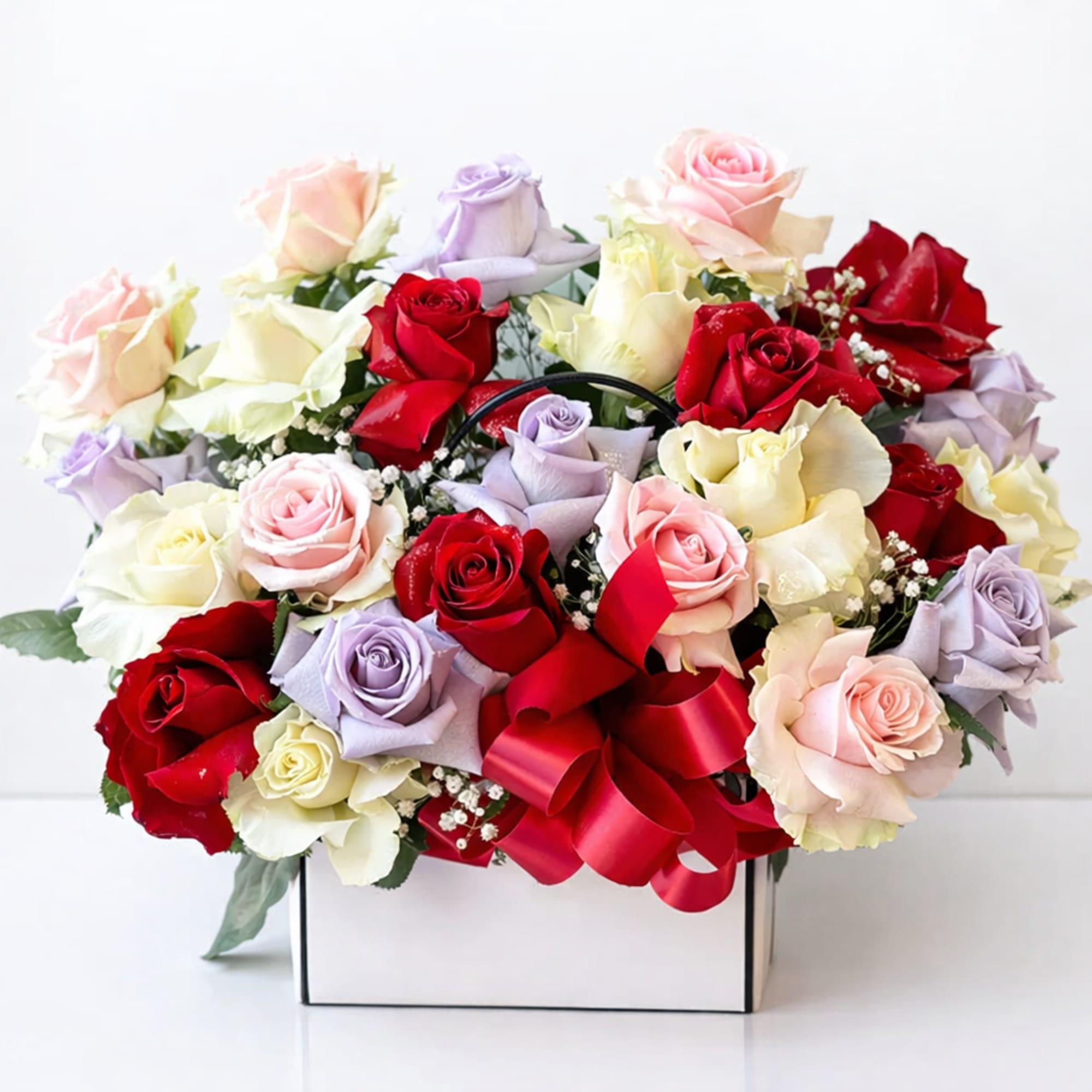 Mixed roses in a white box with a red ribbon bow