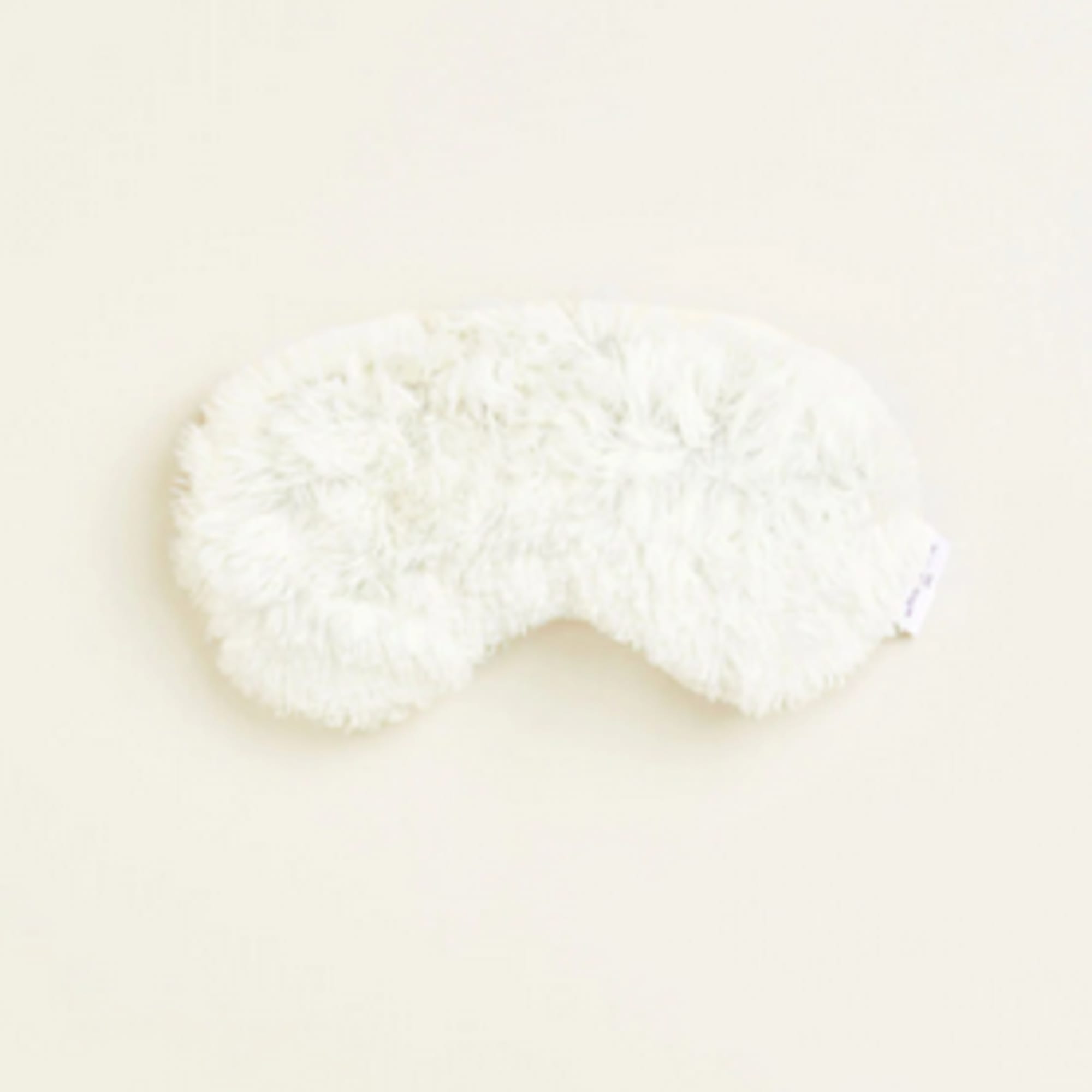 White fluffy eye mask on a light background