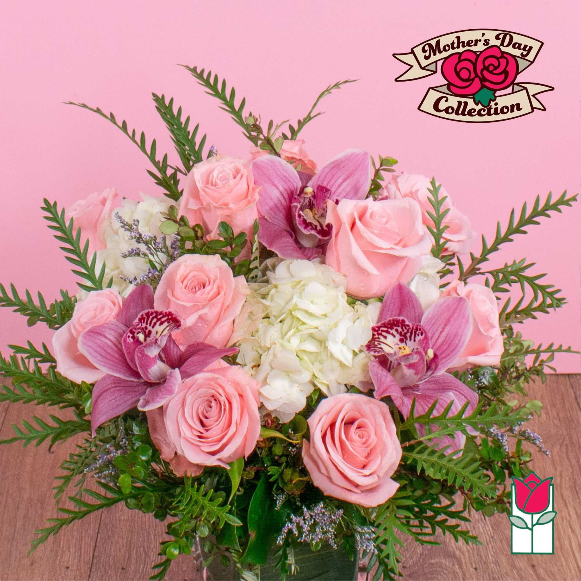 Pink roses and orchids arranged with white hydrangea in a vase