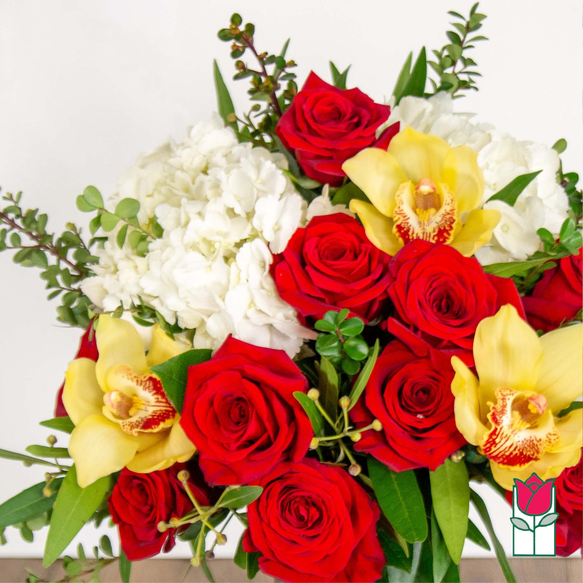 Bouquet of red roses, yellow orchids, and white hydrangeas