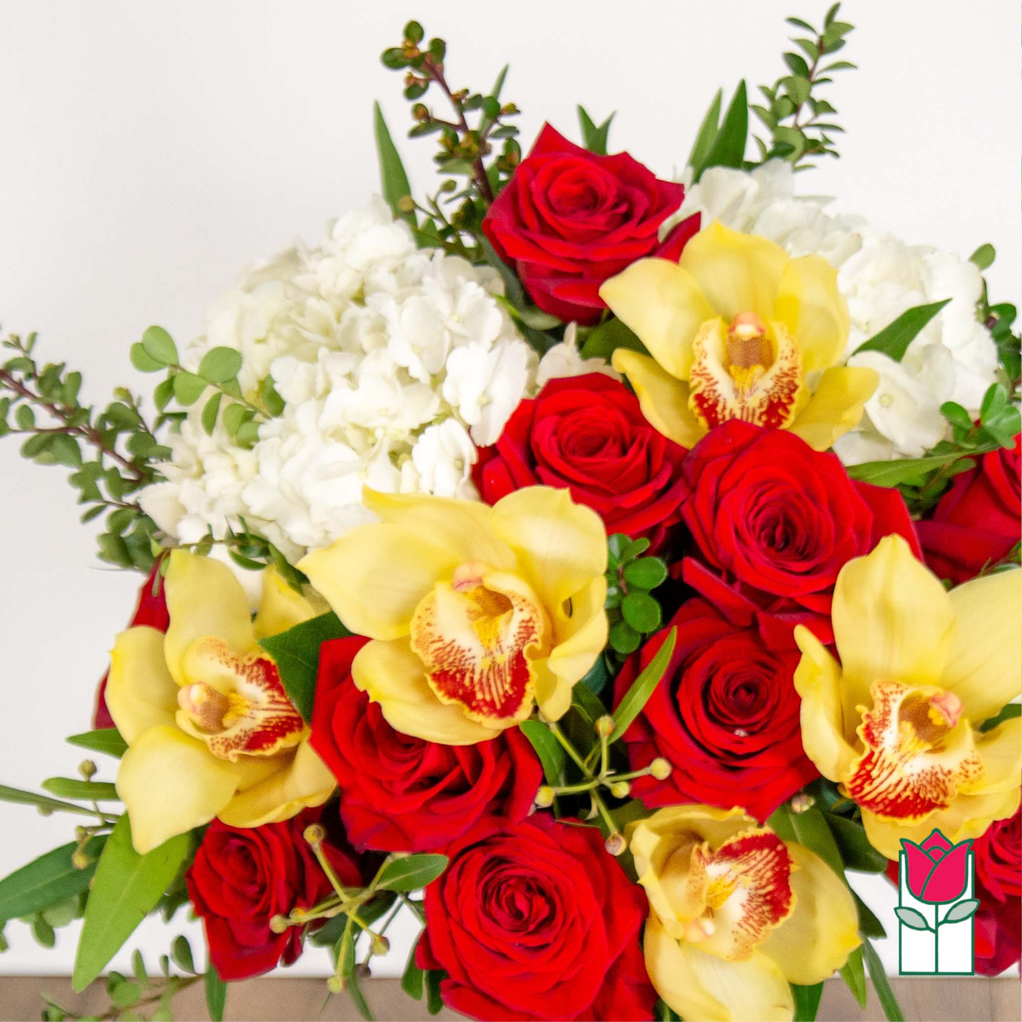 Bouquet of red roses and yellow orchids with white flowers