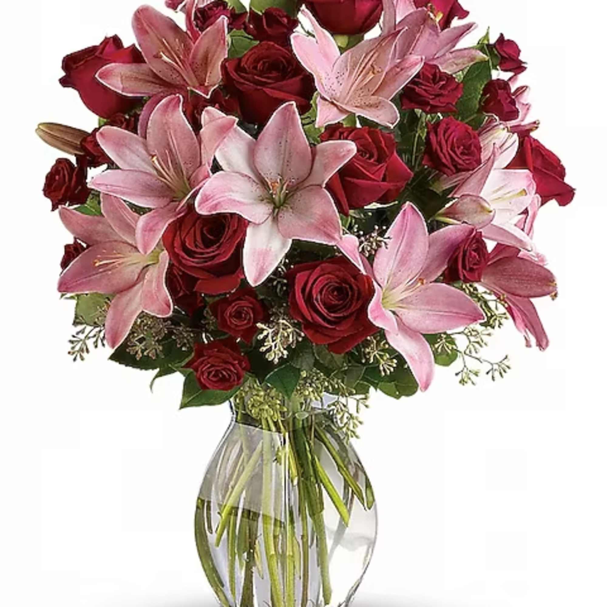Bouquet of red roses and pink lilies in a clear glass vase