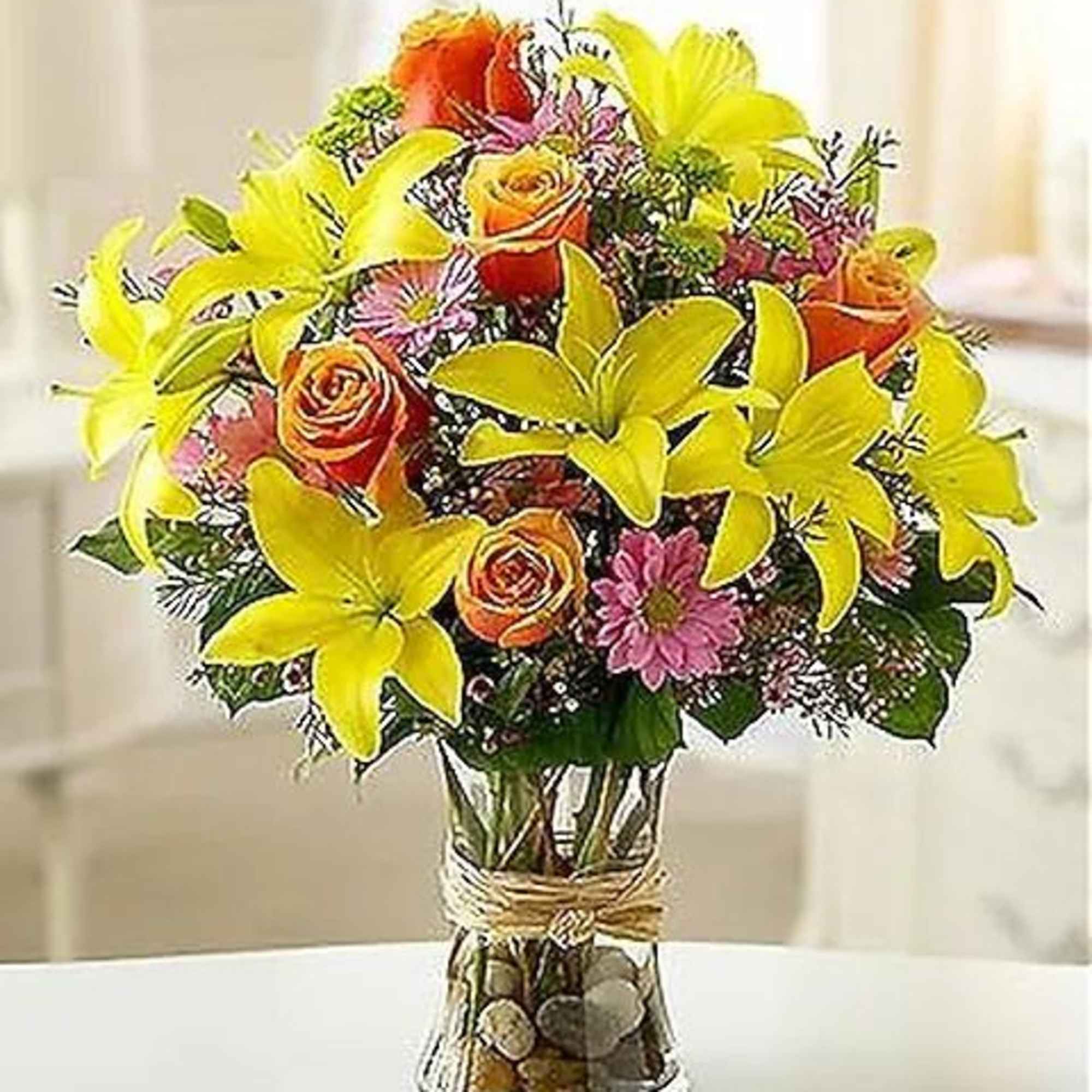 Fields of Europe is a captivating arrangement of fresh lilies, roses, poms