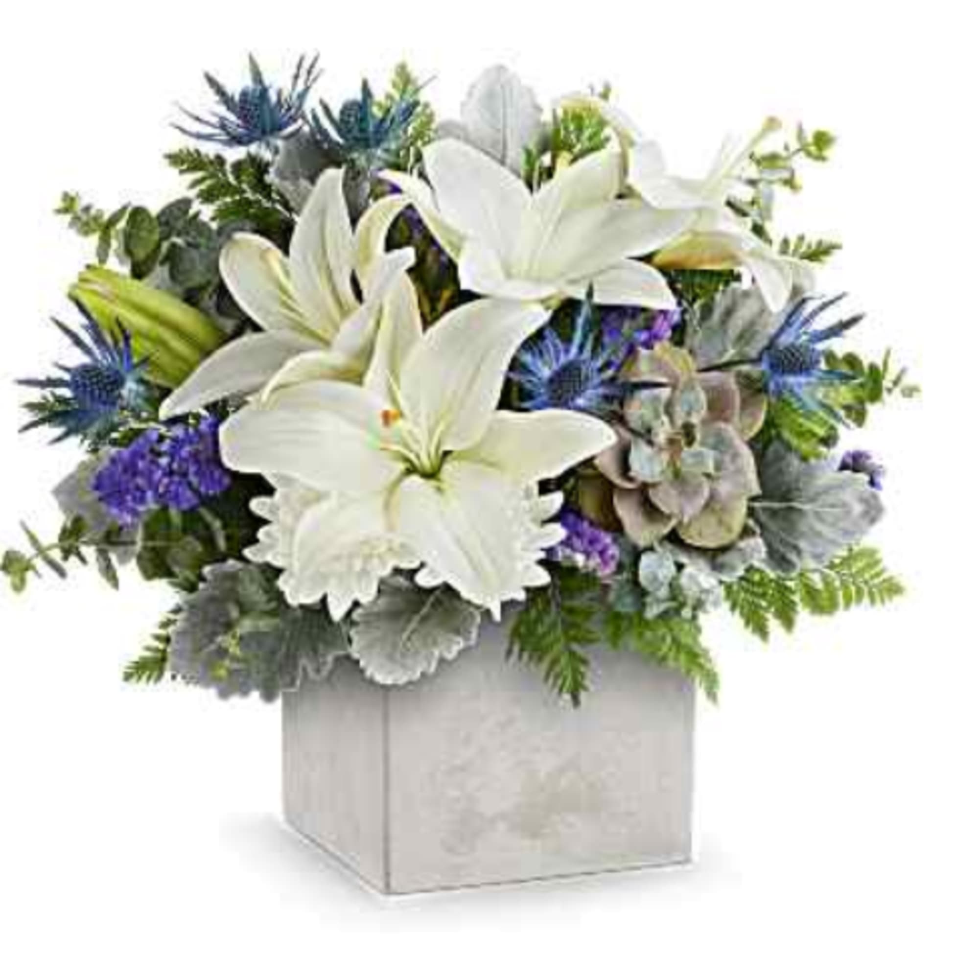 White lilies and blue thistle in a square vase