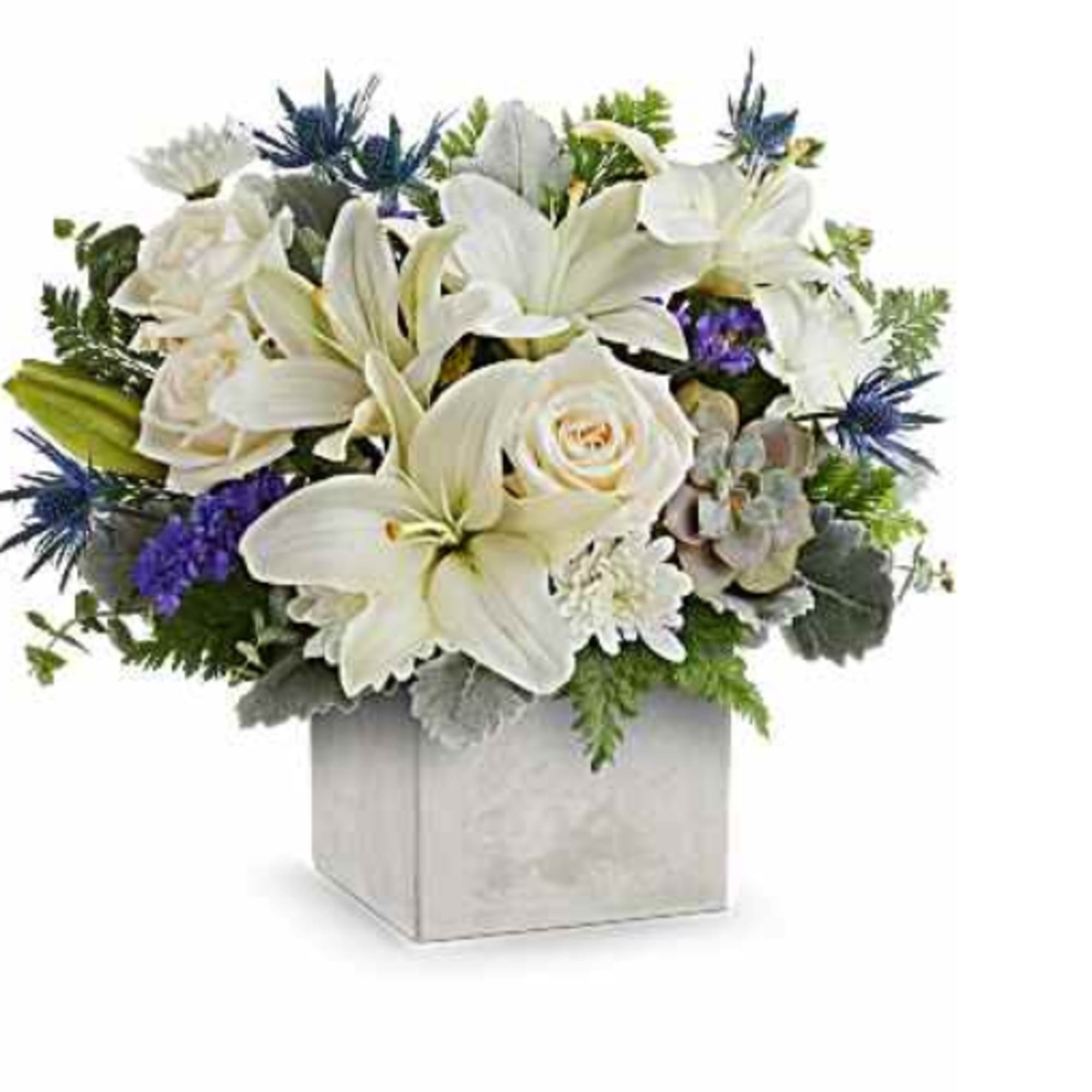 White lilies and roses arranged in a square vase with blue accents