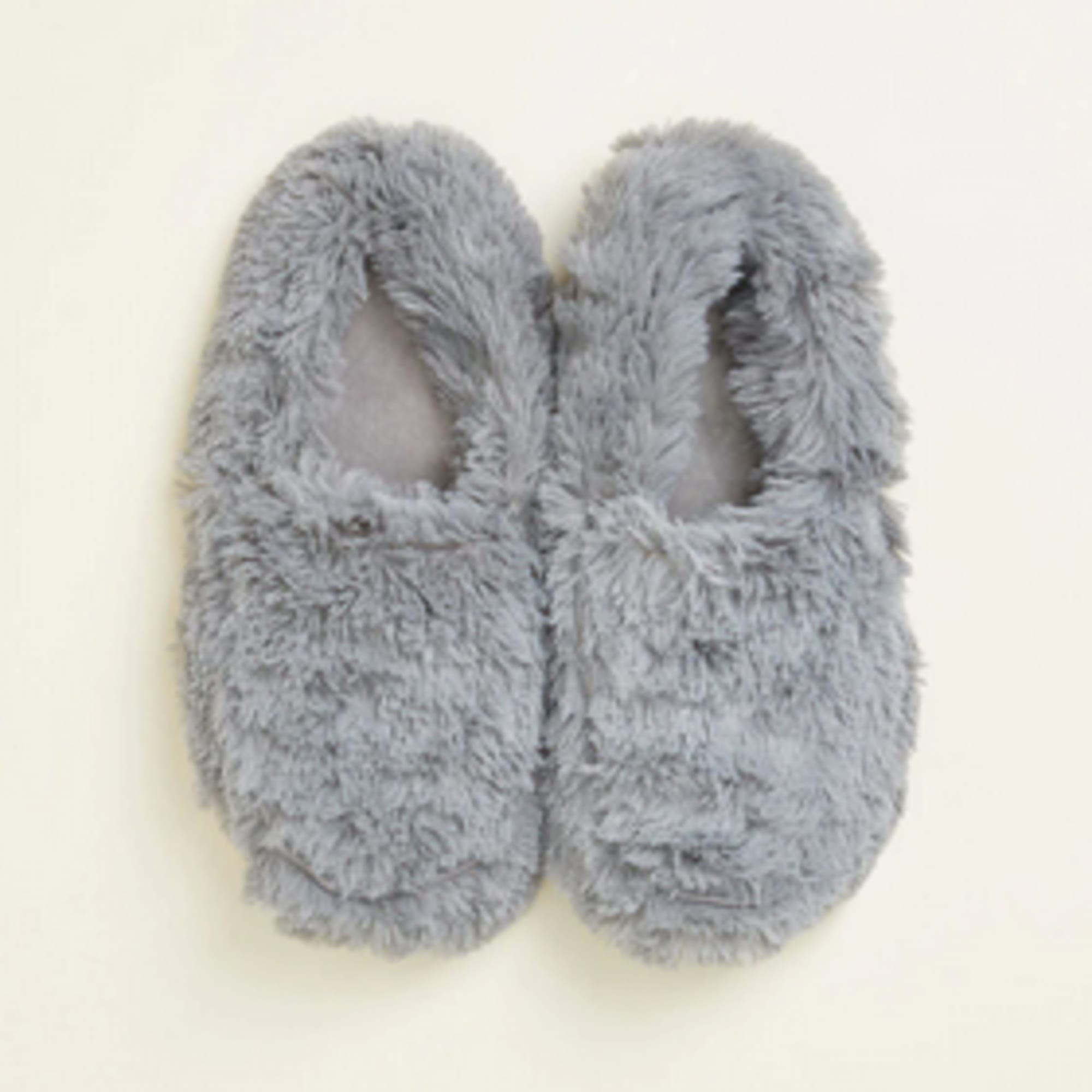 Pair of gray fuzzy slippers on a light background