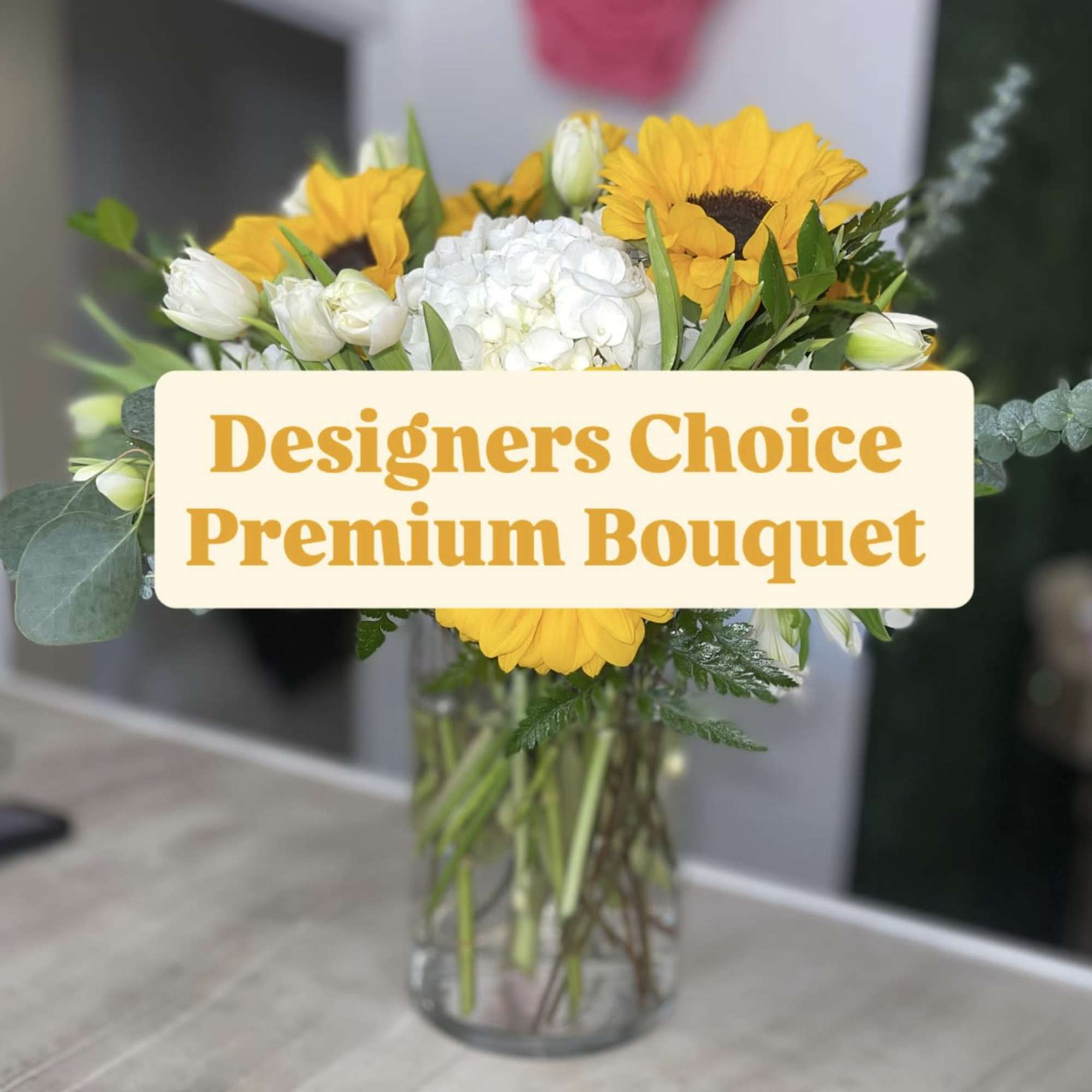 Bouquet of yellow sunflowers and white flowers in a glass vase