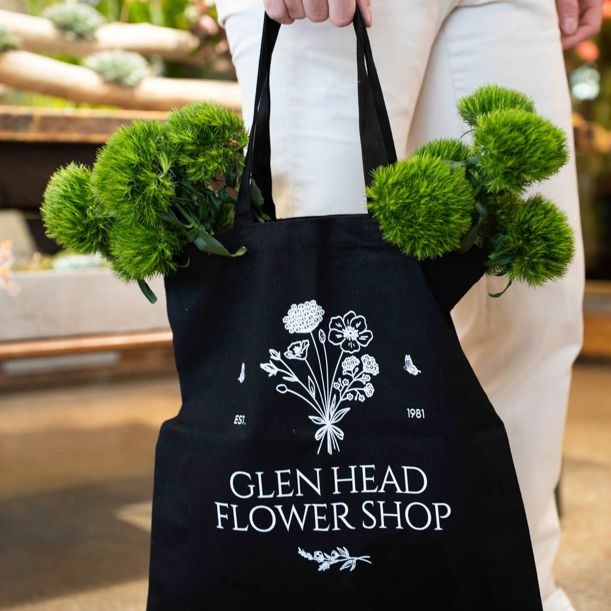 A chic black and white GHFS signature tote bag. Measuring 15" x