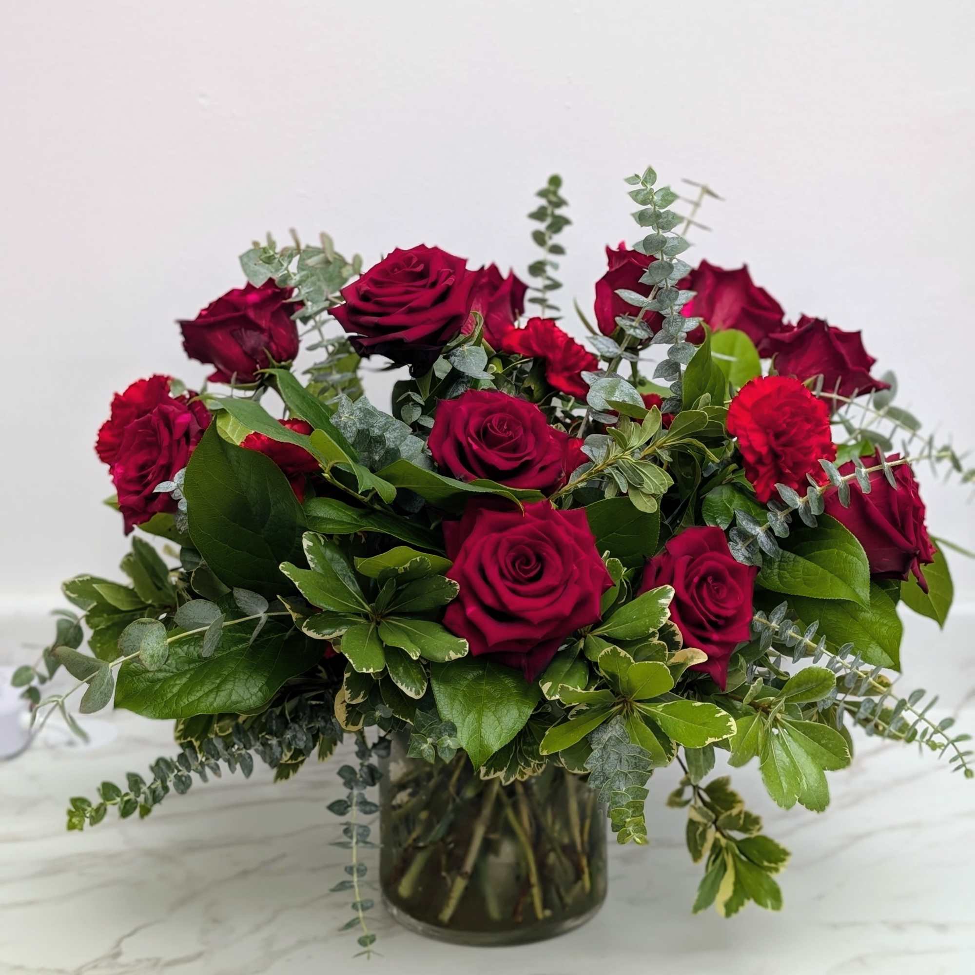Bouquet of deep red roses in a glass vase