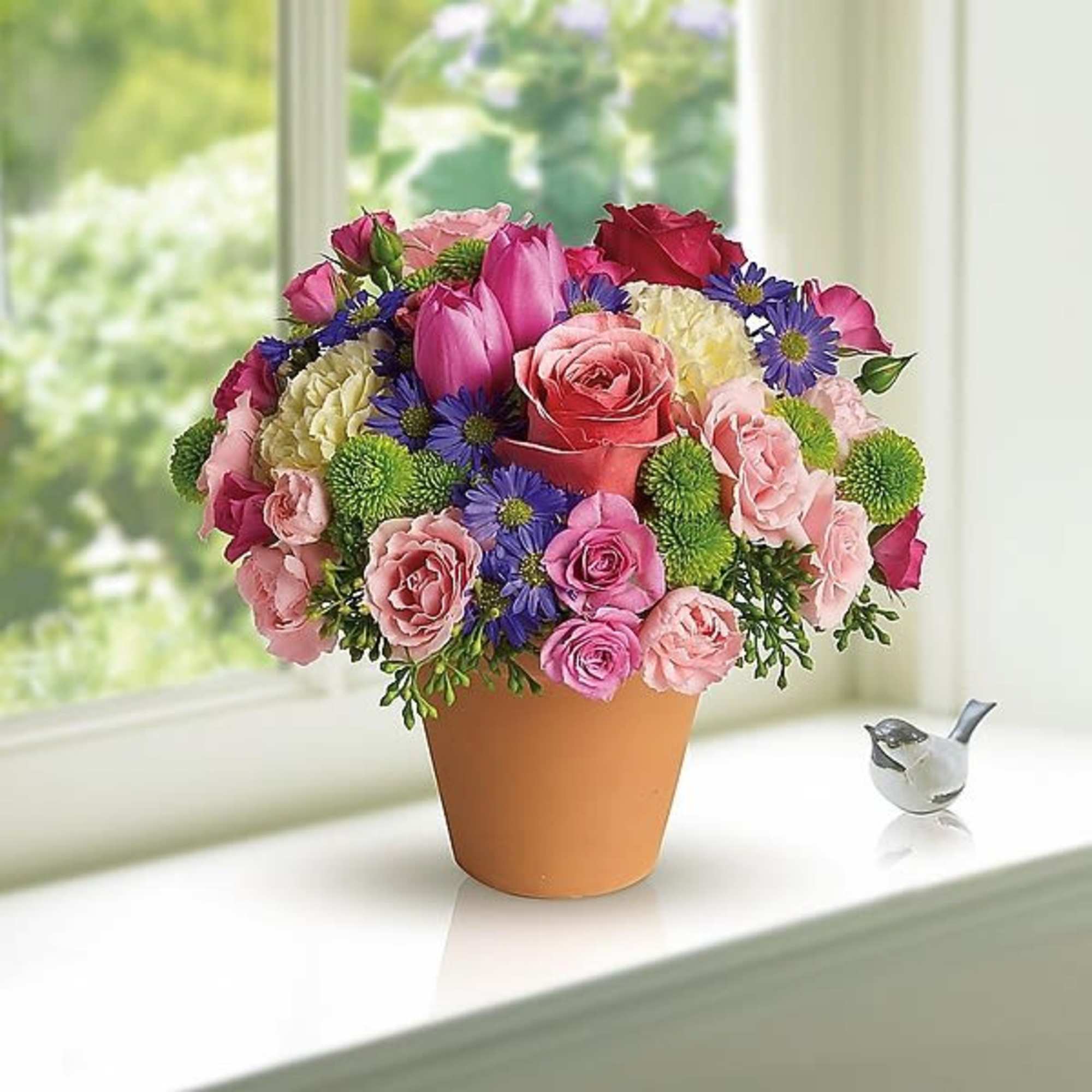 A warm terra-cotta pot and lots of fun colors give this bouquet