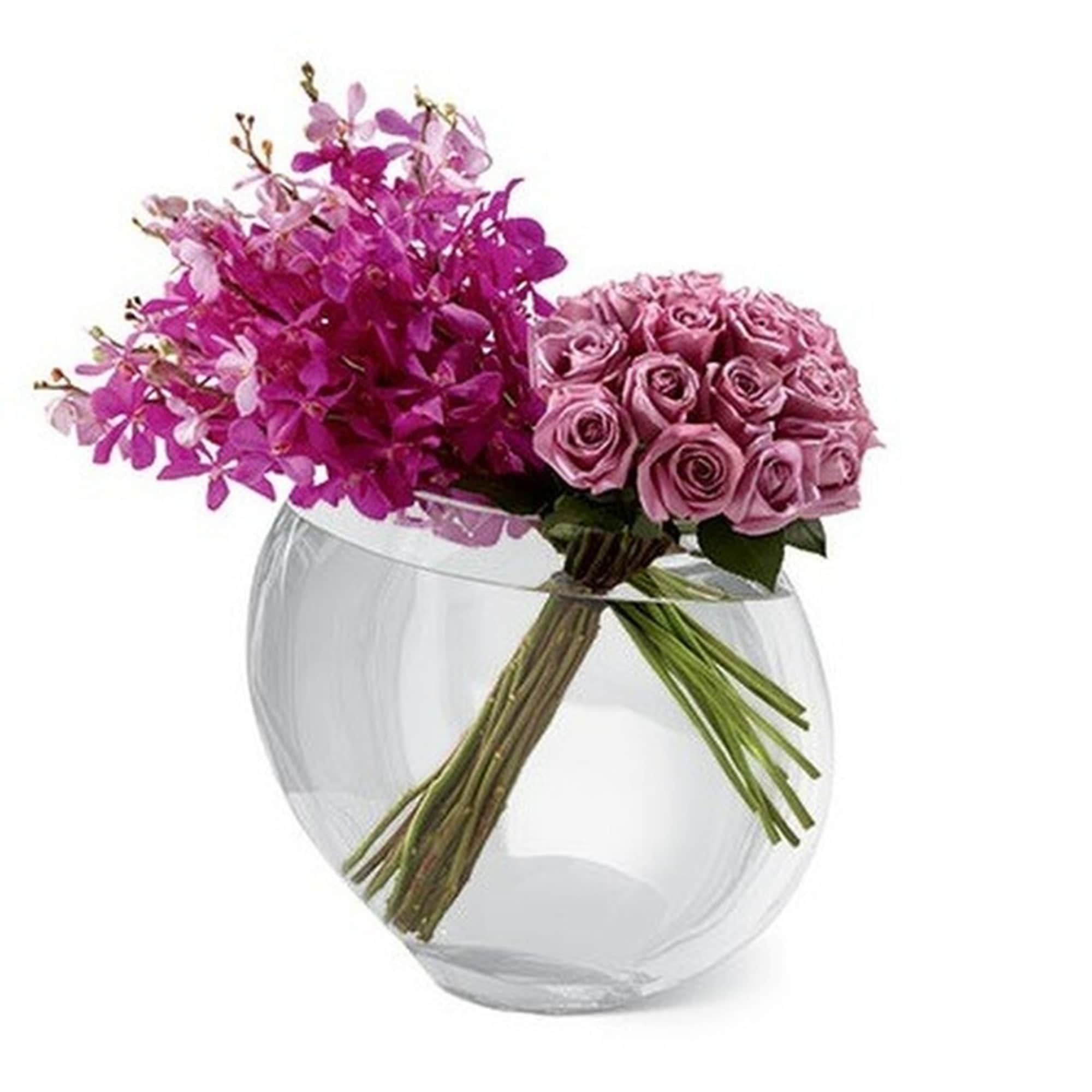 Modern arrangement of pink orchids and lavender roses in a clear round glass vase