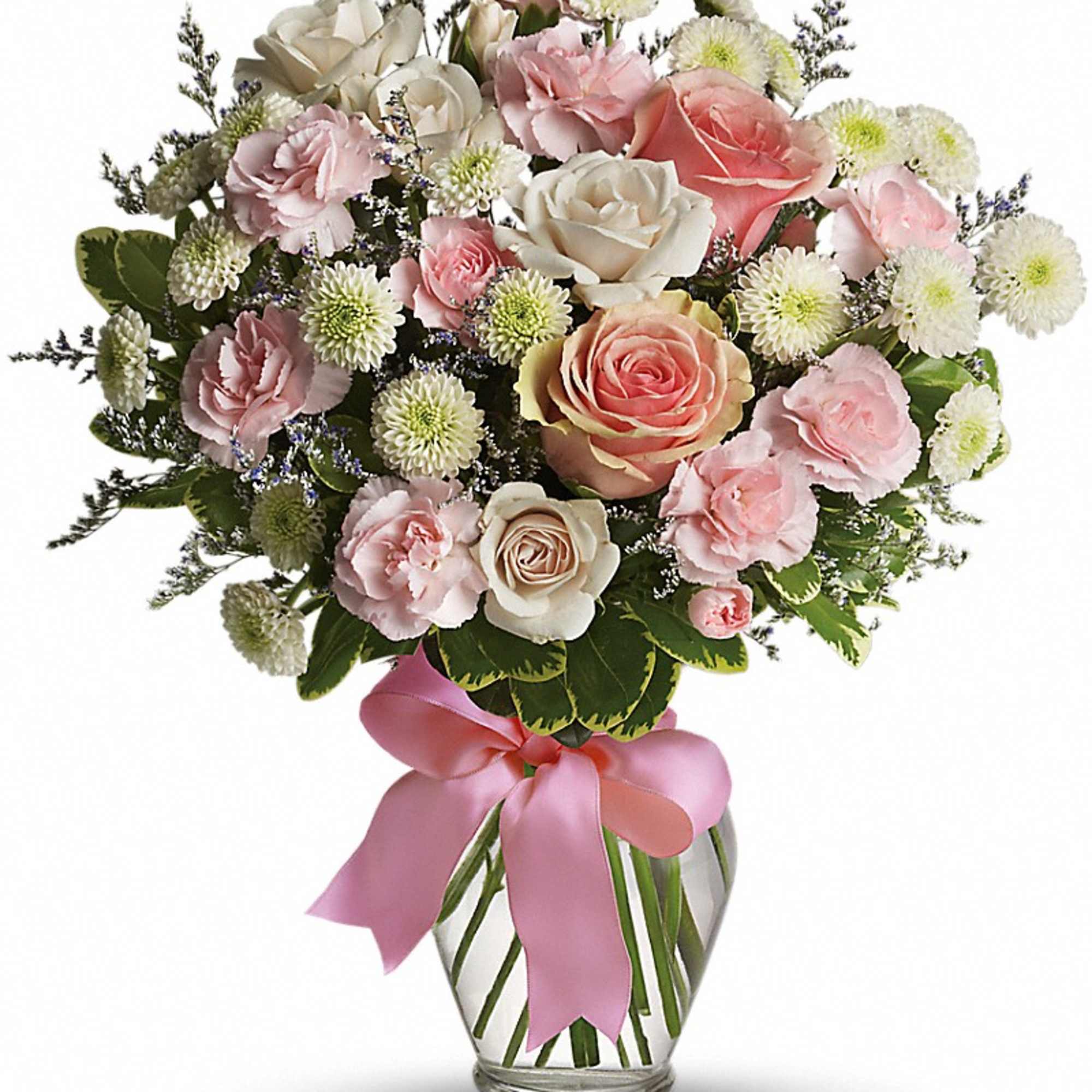 Pink and white roses, carnations, and mums in a clear glass vase with a pink ribbon bow