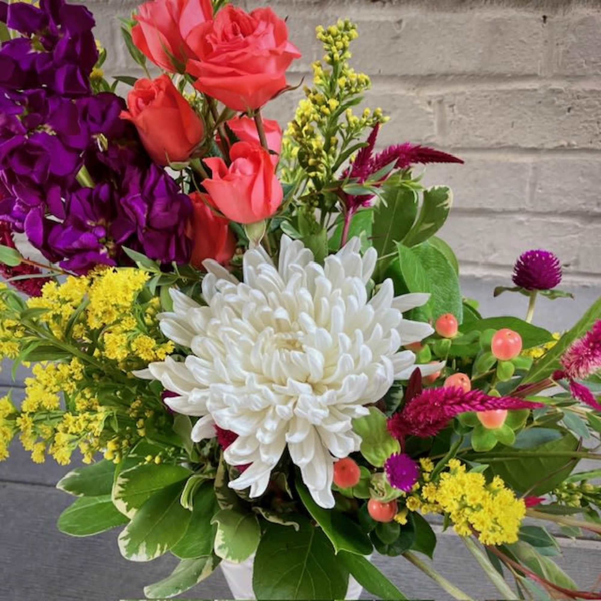 "Brilliant Blossoms" is a beautiful and petite floral design of vibrant flowers