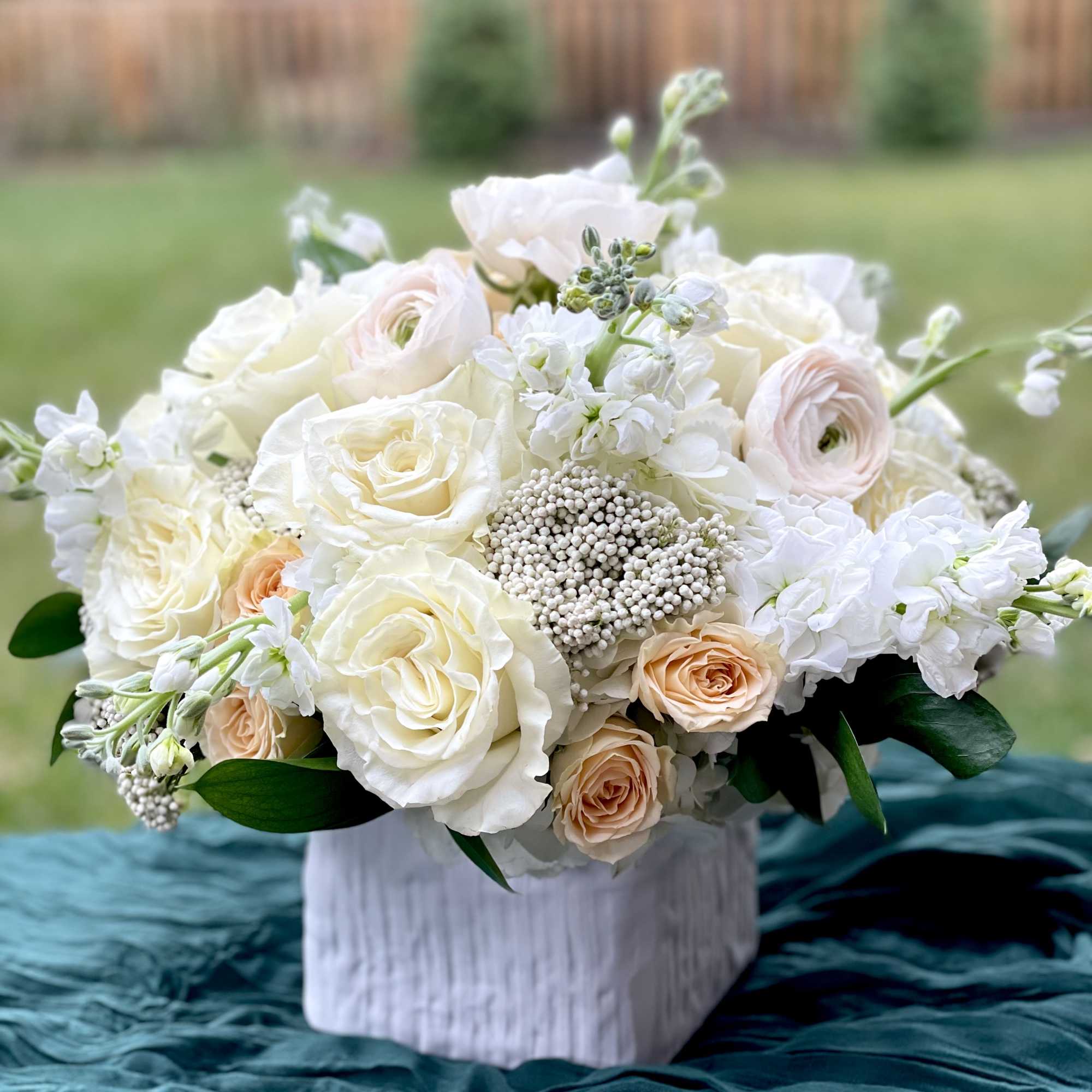 White and blush bouquet in a white vase