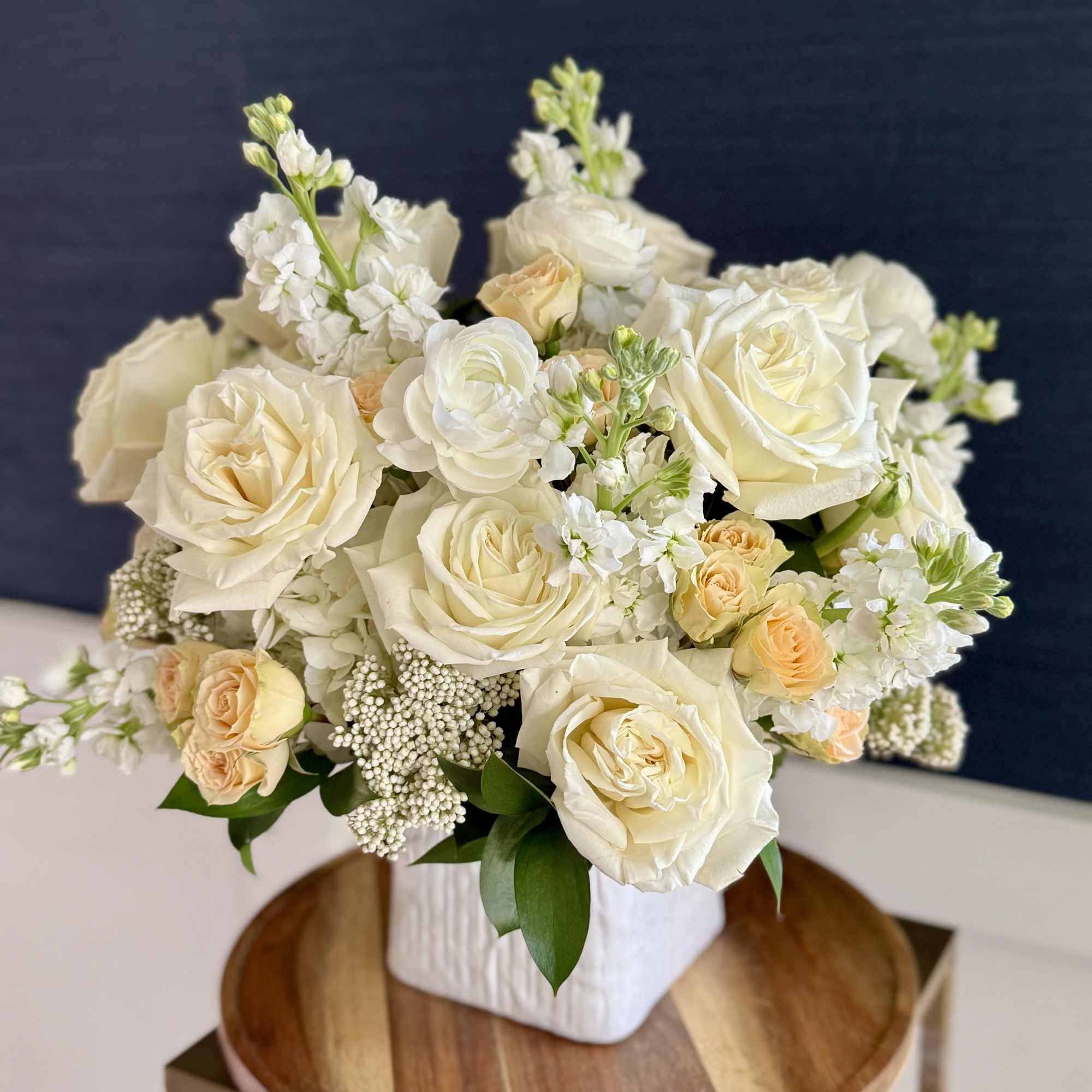 A neutral pallet of roses, ranunculus, stock and spray roses. Perfect for