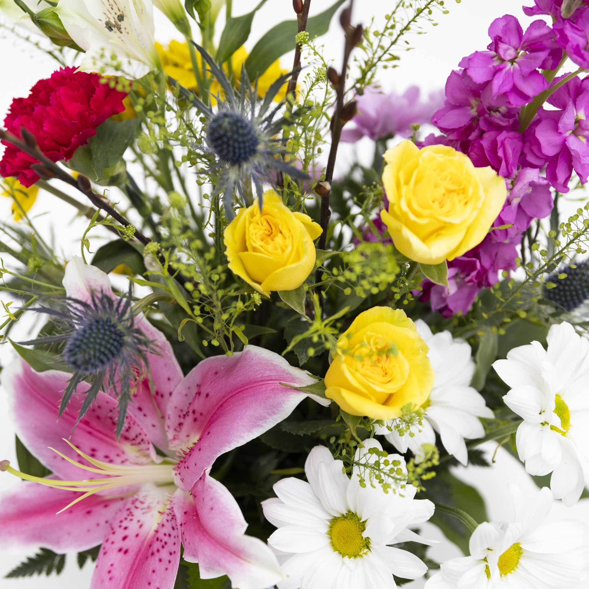 Mixed bouquet with pink lily, yellow roses, and white daisies