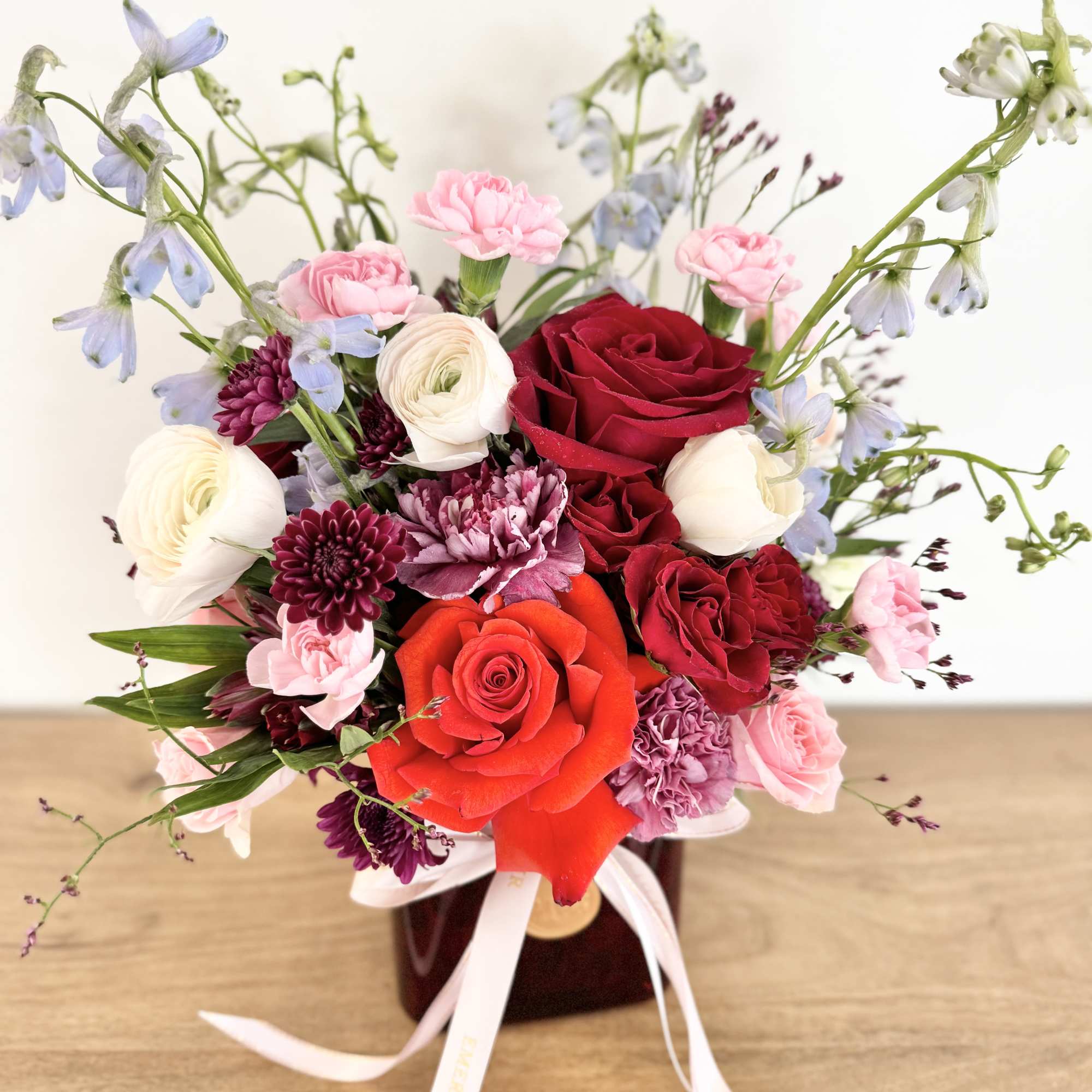 Ruby Femme is a confident and romantic floral design arranged in red