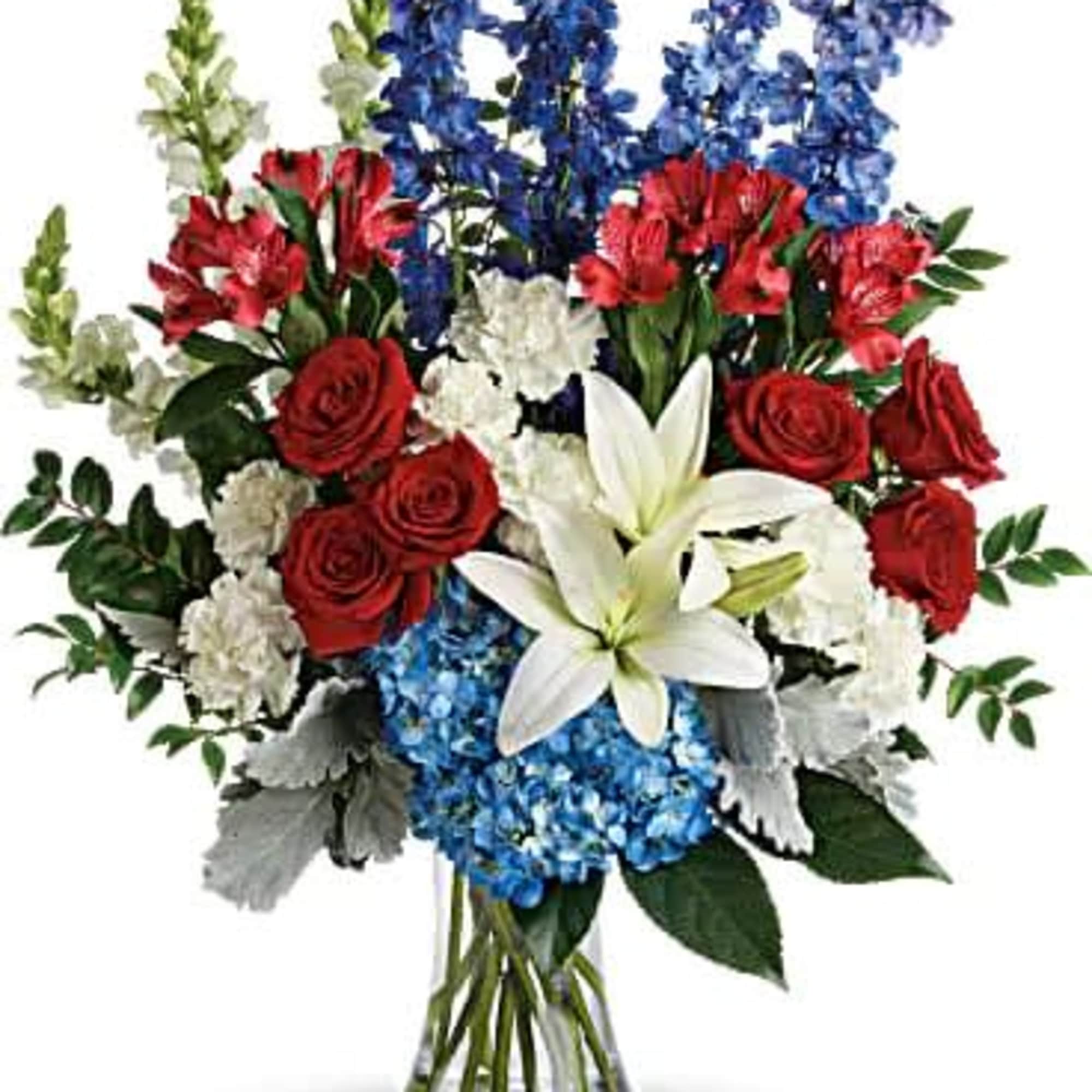 Bouquet of red roses, blue flowers, and white lilies in a glass vase